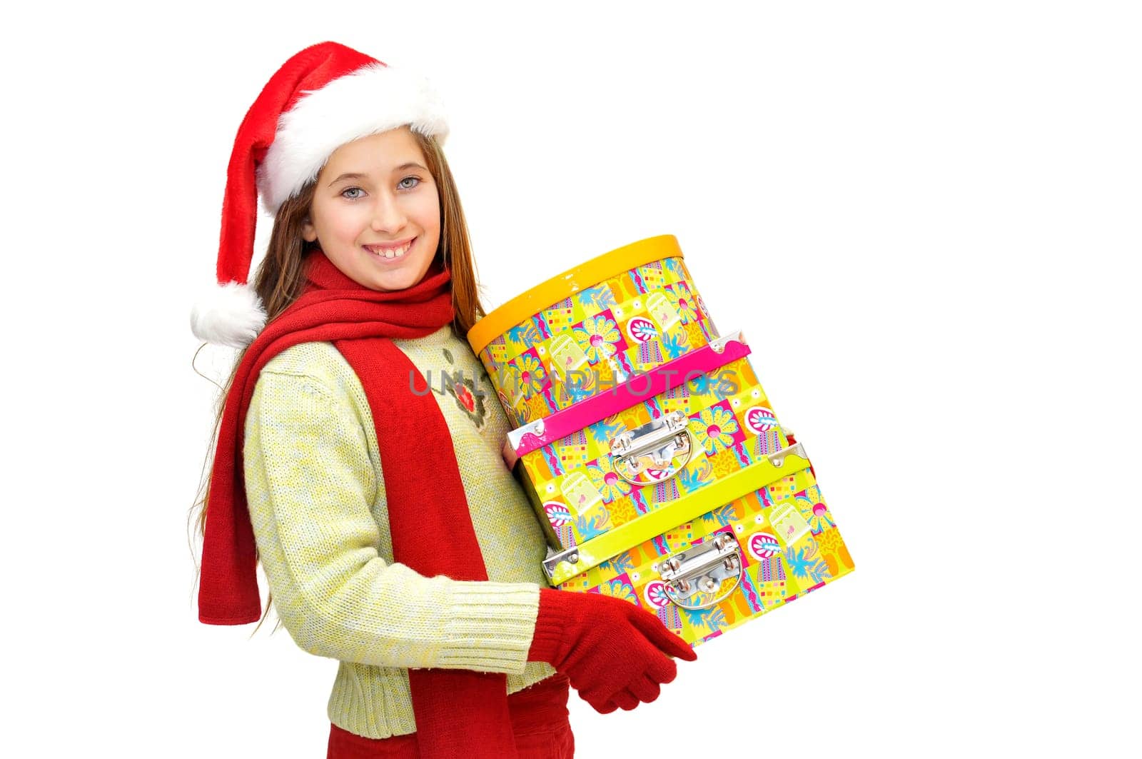 Beautiful young girl with santas hat and gif boxes isolated in white