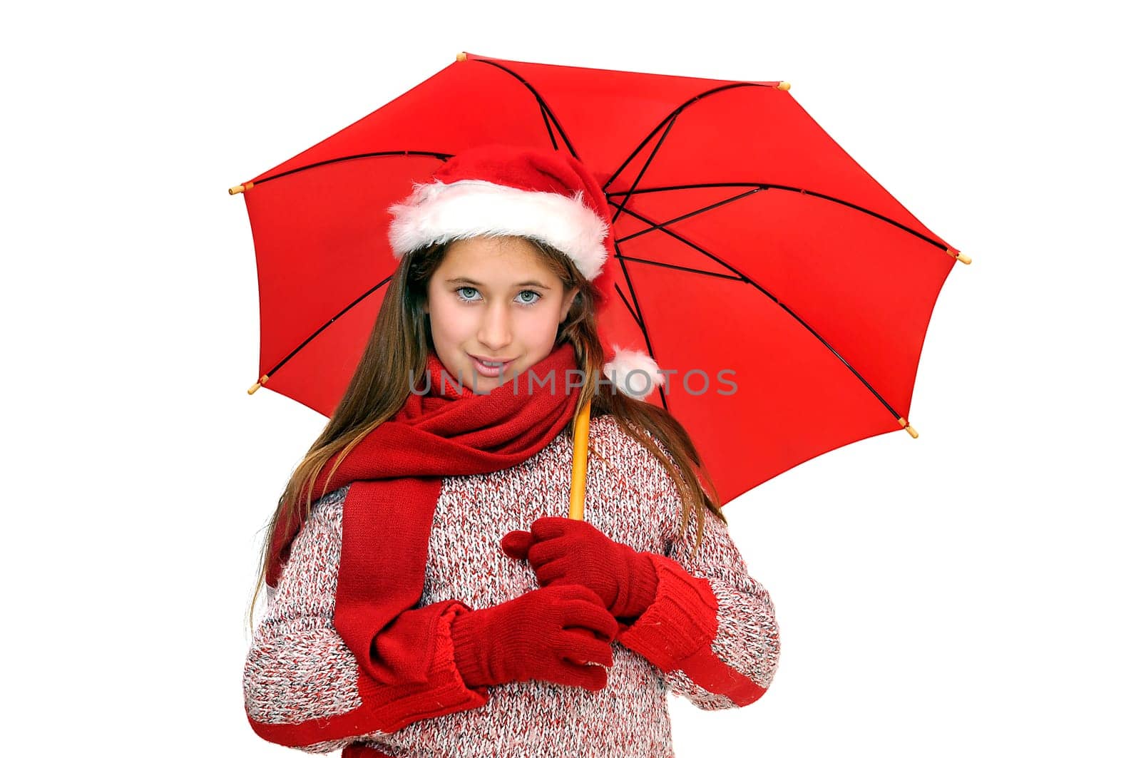 Beautiful young girl with santas hat and red umbrella isolated in white