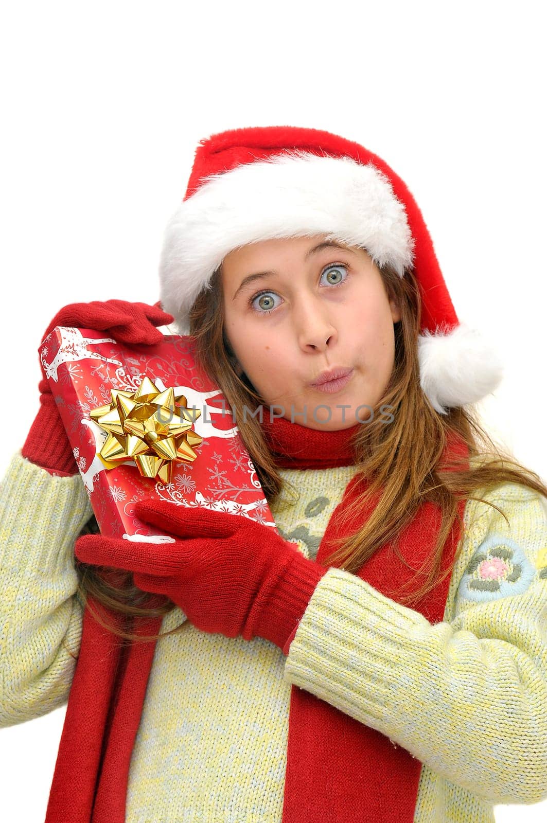 Beautiful young girl with santas hat and shopping bags isolated in white