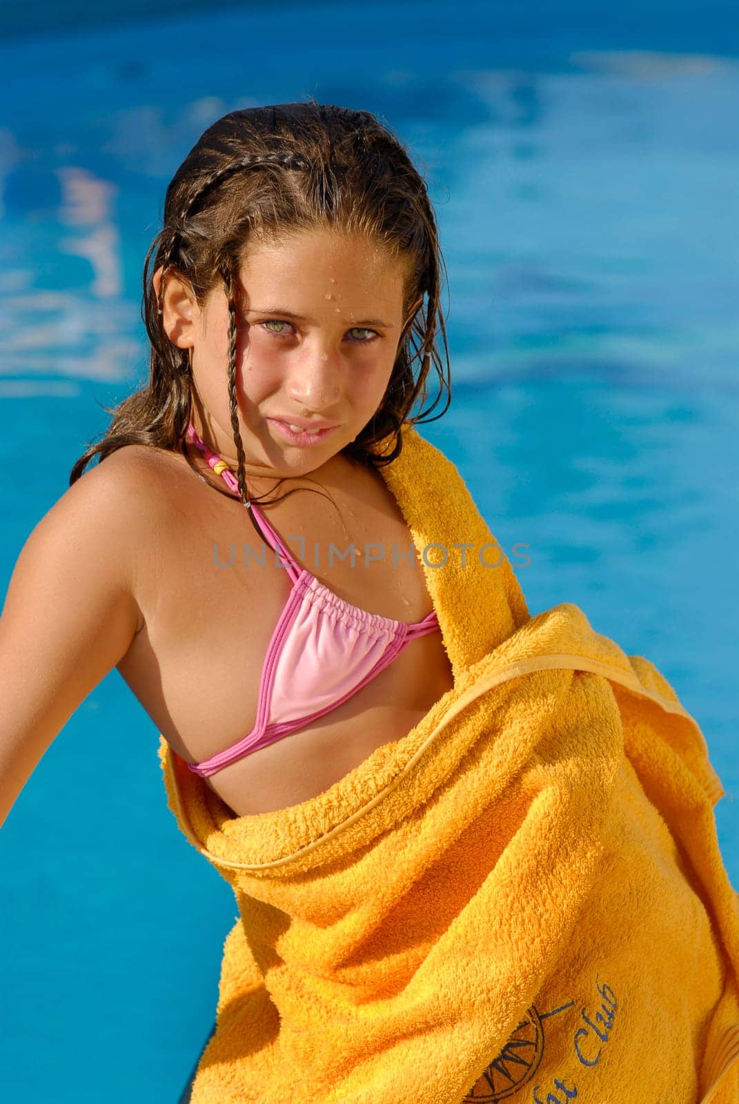 Beautiful girl with green eyes, posing in a pool