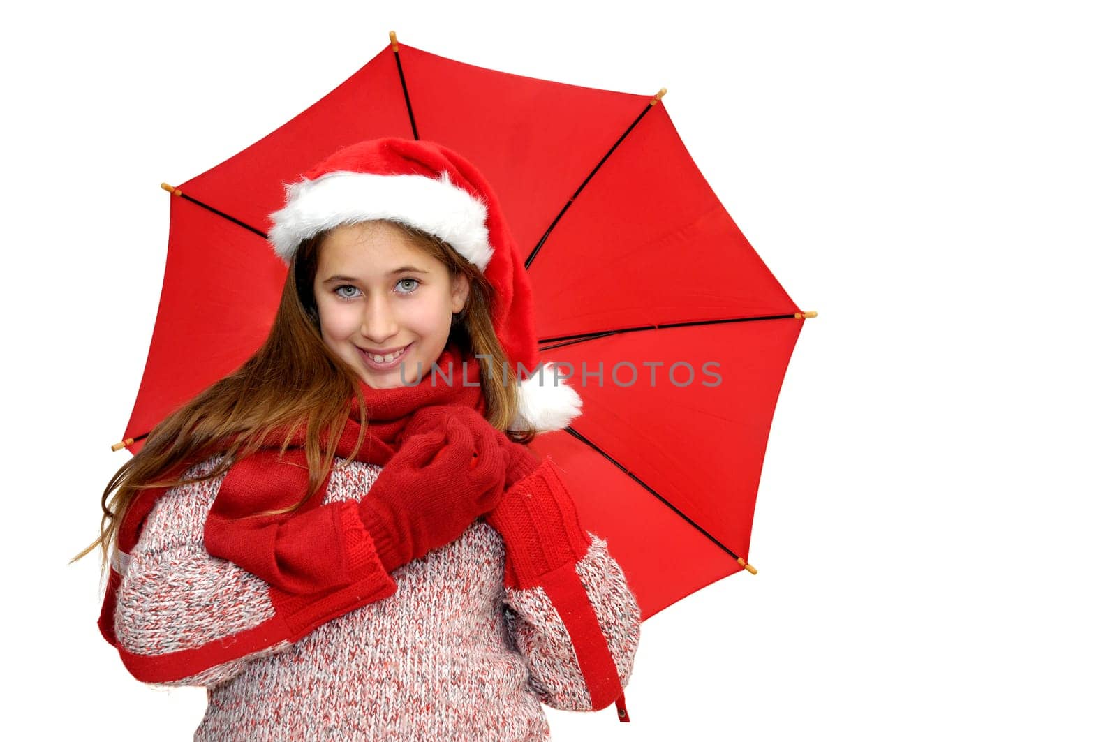 Beautiful young girl with santas hat and red umbrella isolated in white