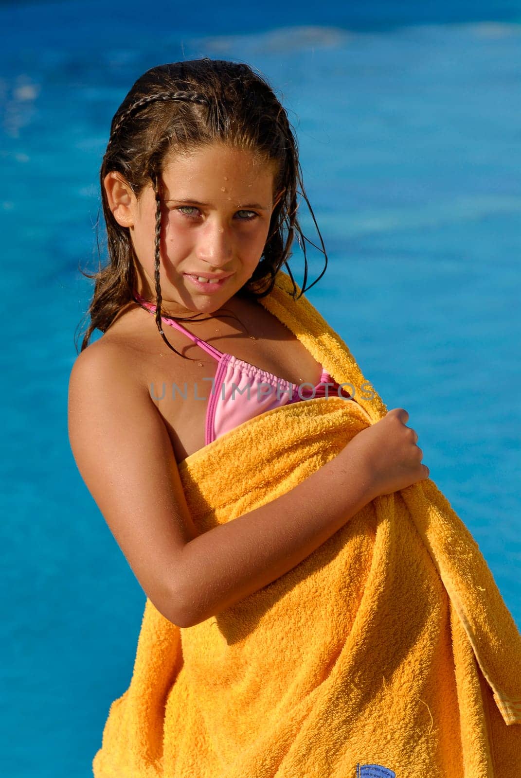 Beautiful young girl posing in a pool