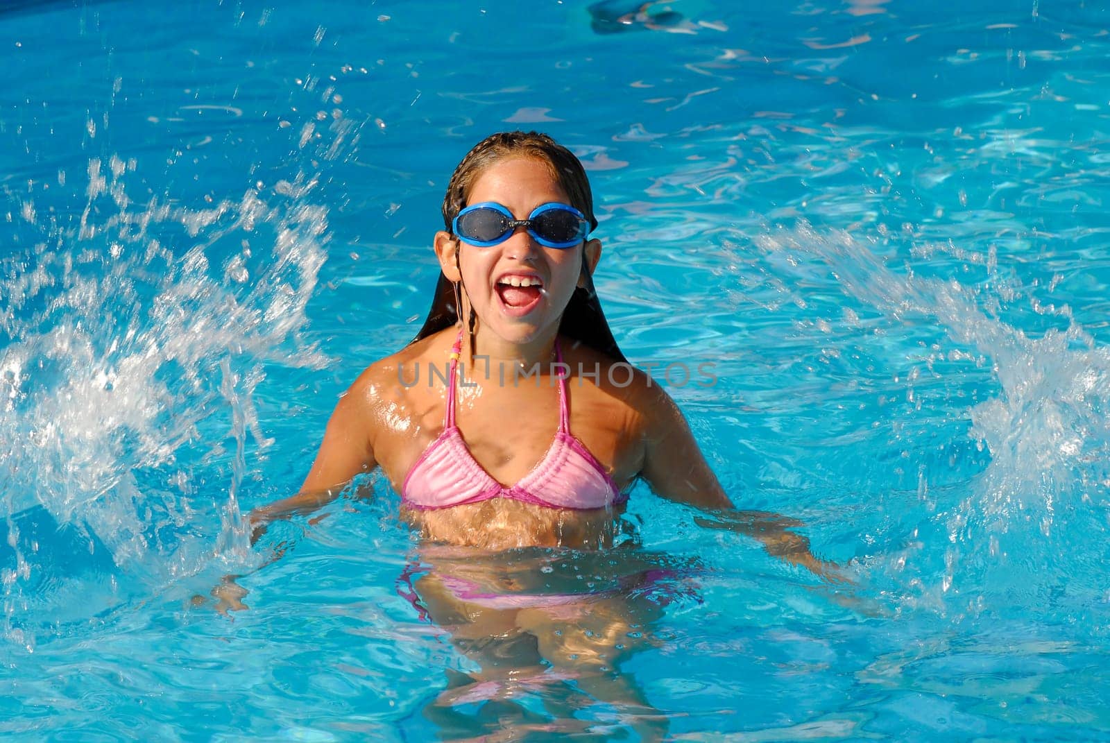 Young girl playing on the pool
