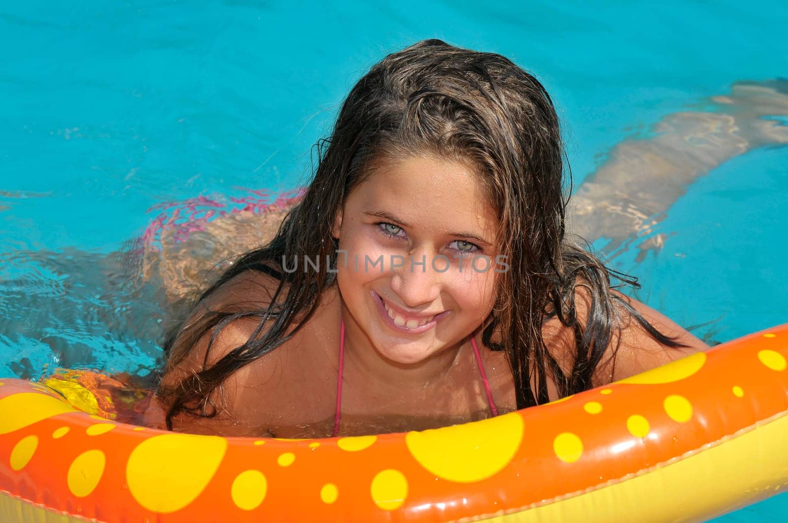 Beautiful girl posing in a swimming pool