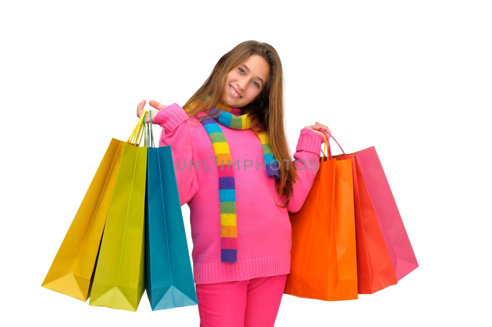 Beautiful young girl with colorful bags isolated in white