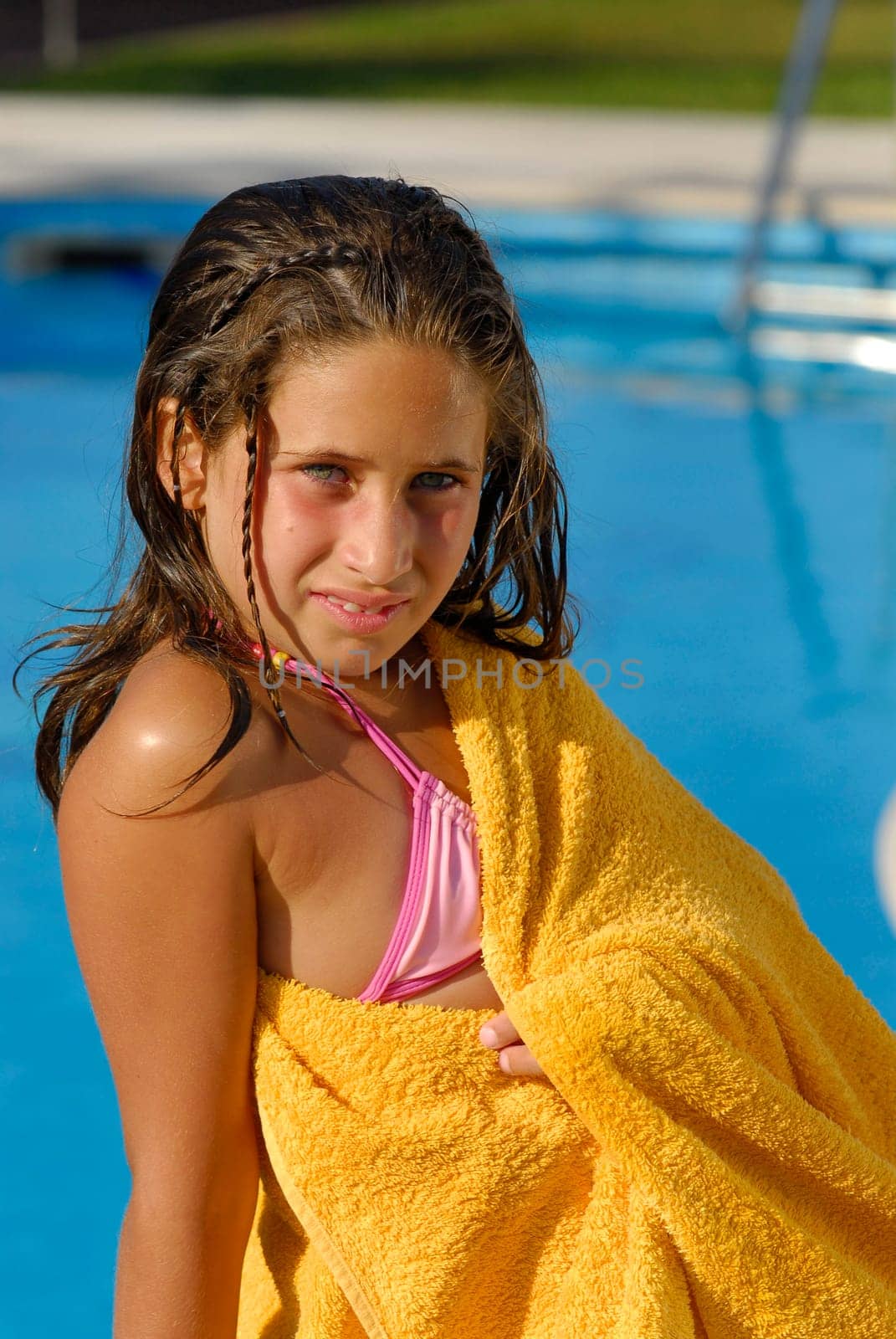 Beautiful girl posing near a pool on summer