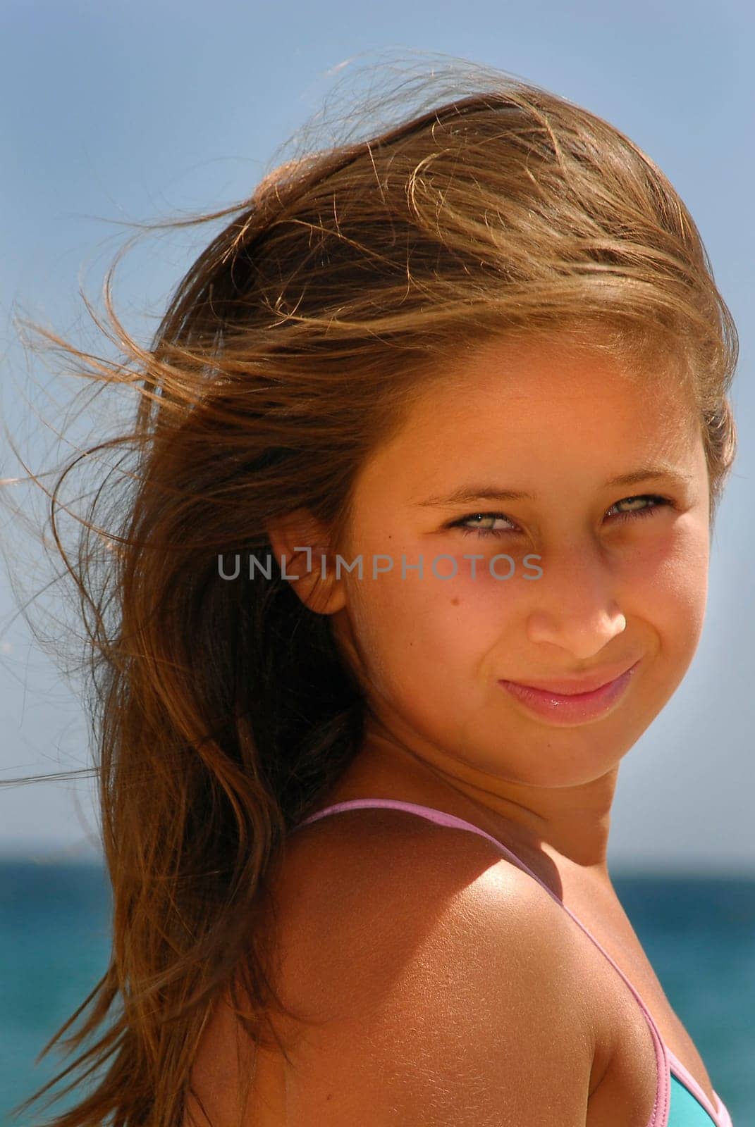 Beautiful young girl posing in the beach