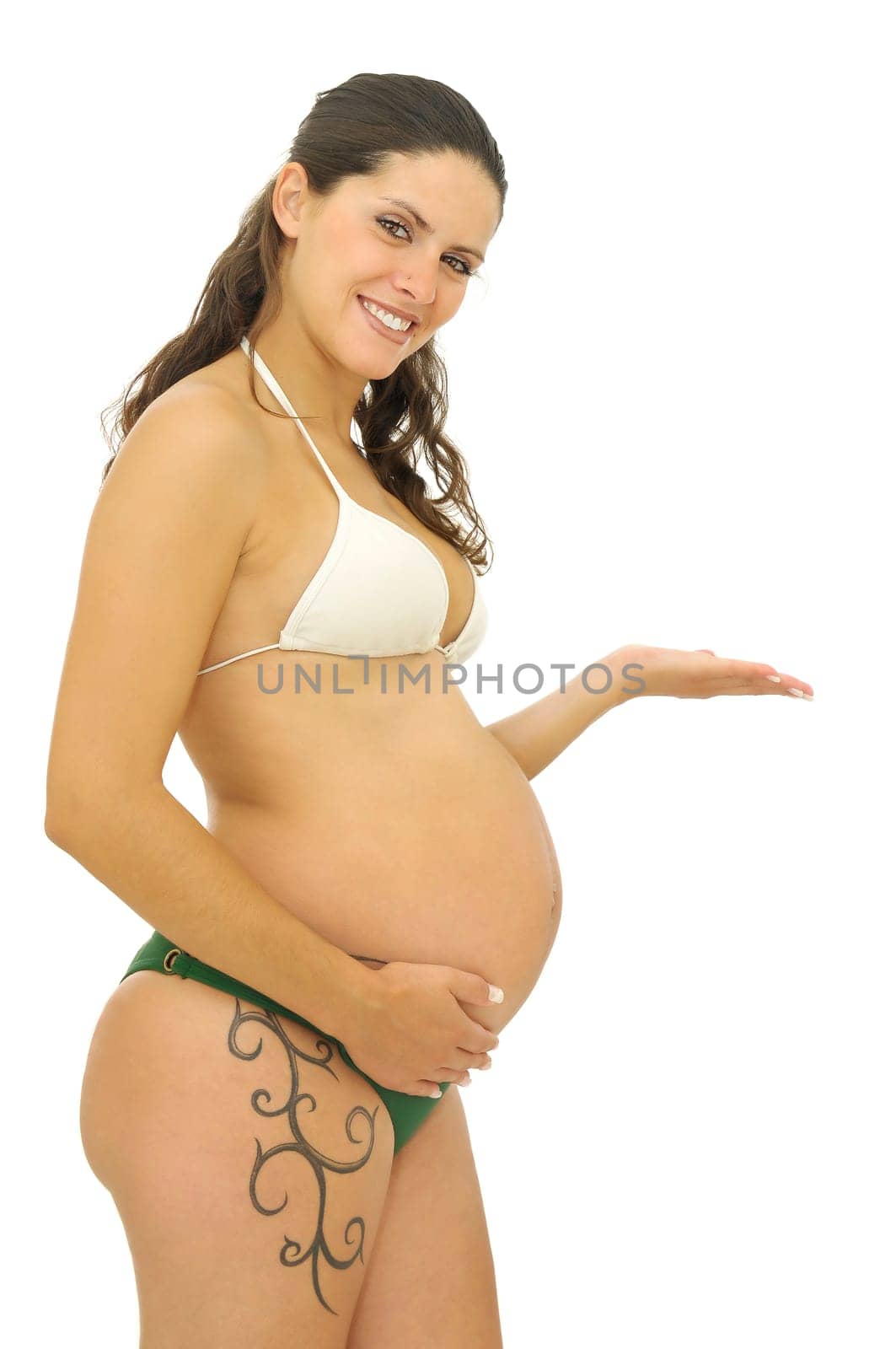 Pregnant woman with tattoo in bikini isolated in white
