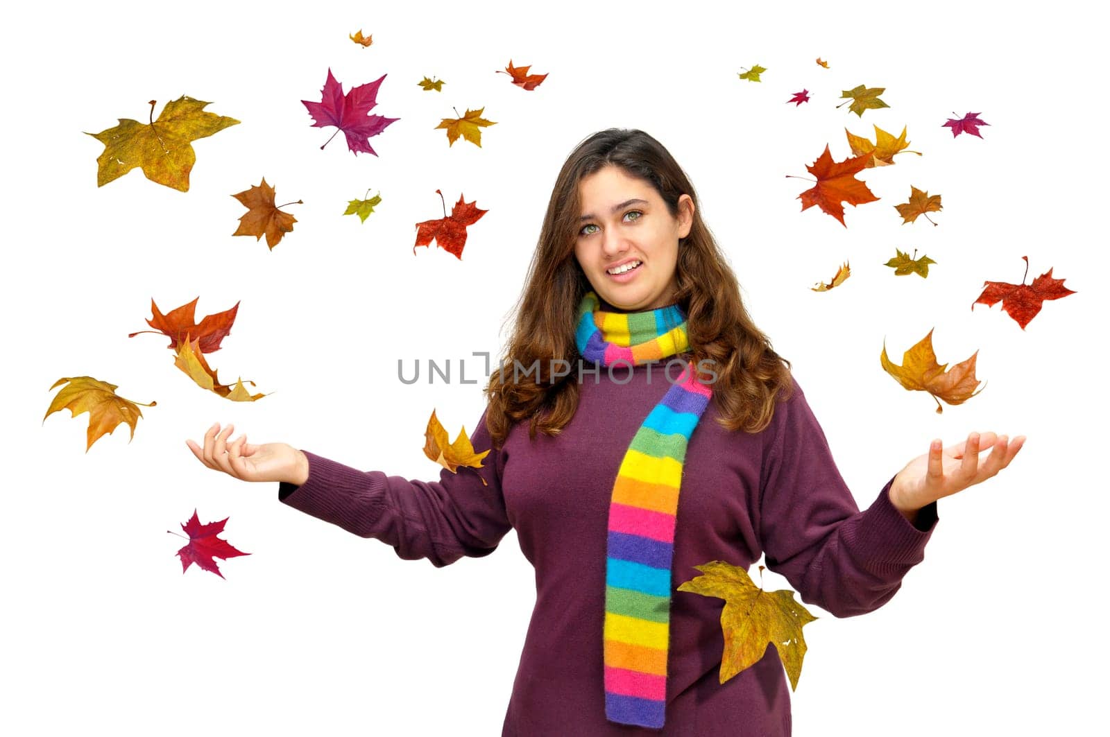 Beautiful teen with Autumn leaves falling all around isolated in white