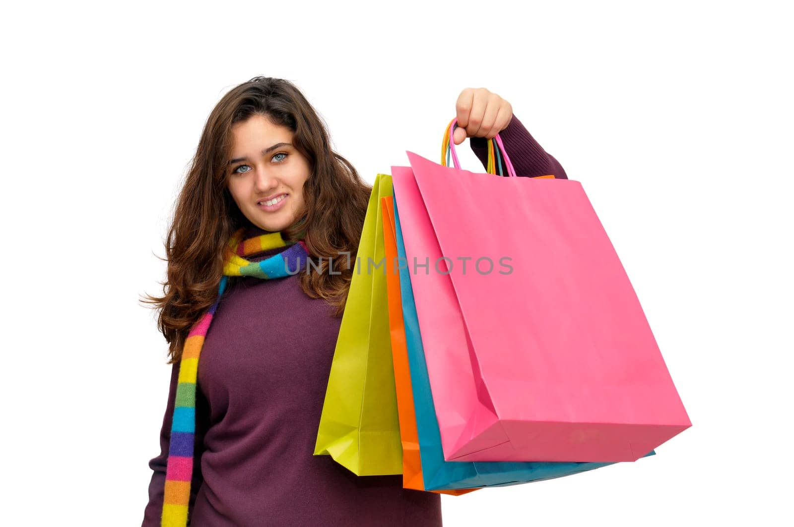 Beautiful teen with colorful bags isolated in white