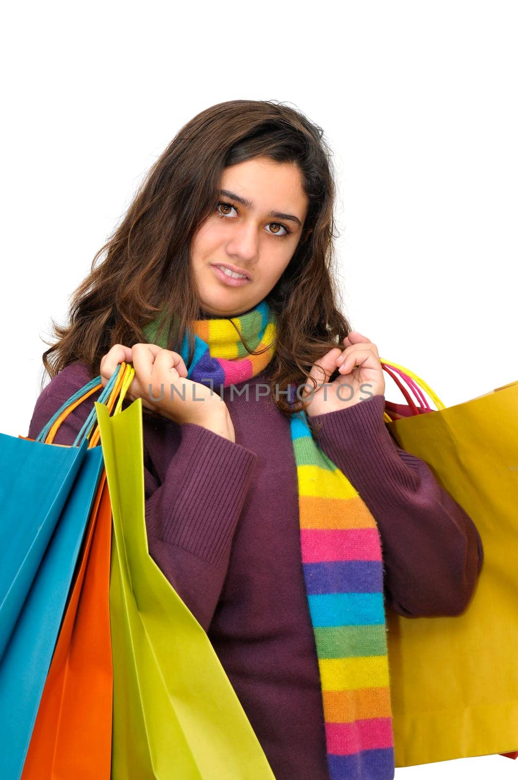 Beautiful teen with colorful bags isolated in white