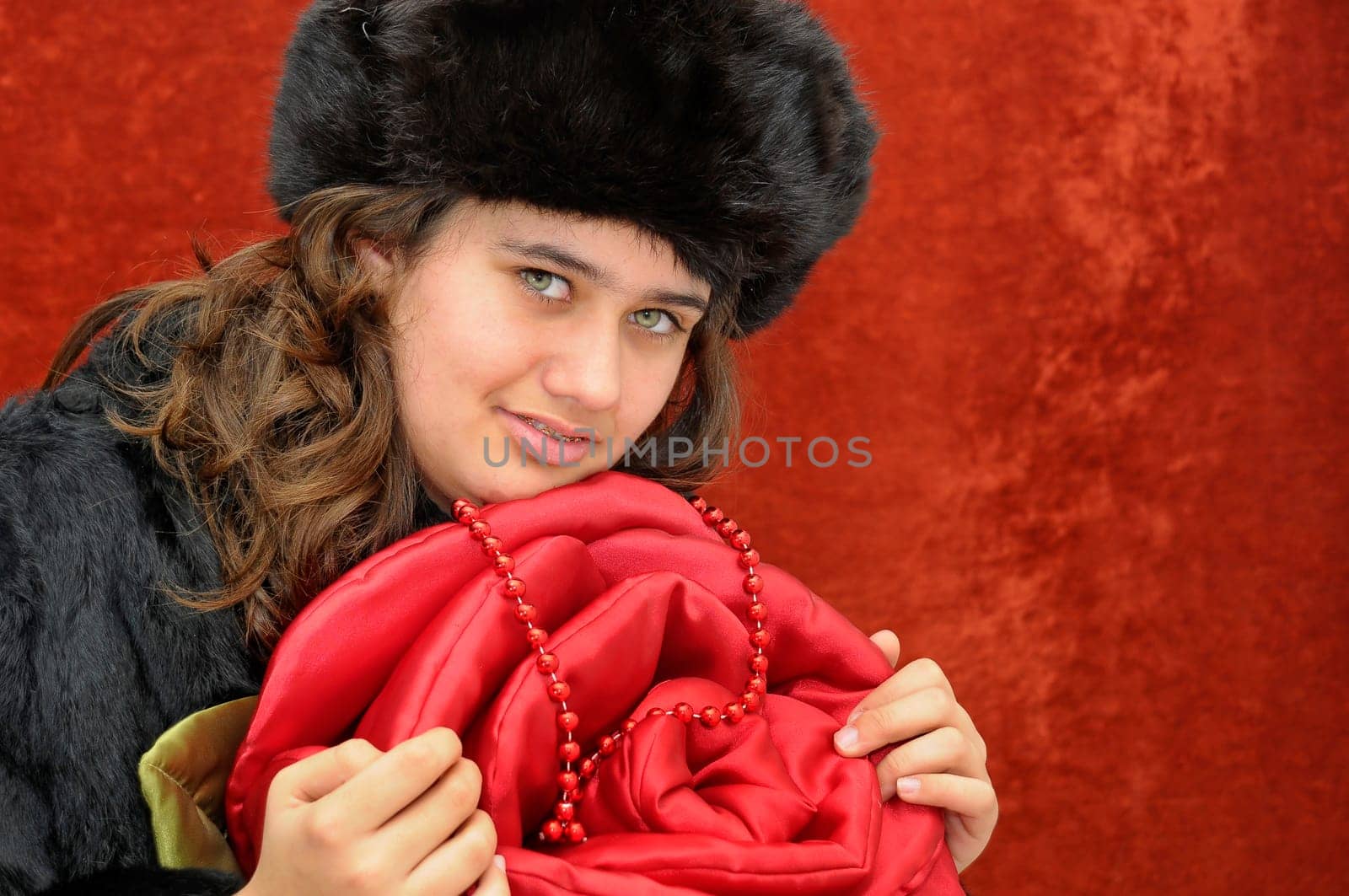 Beautiful girl with roses isolated in a red background