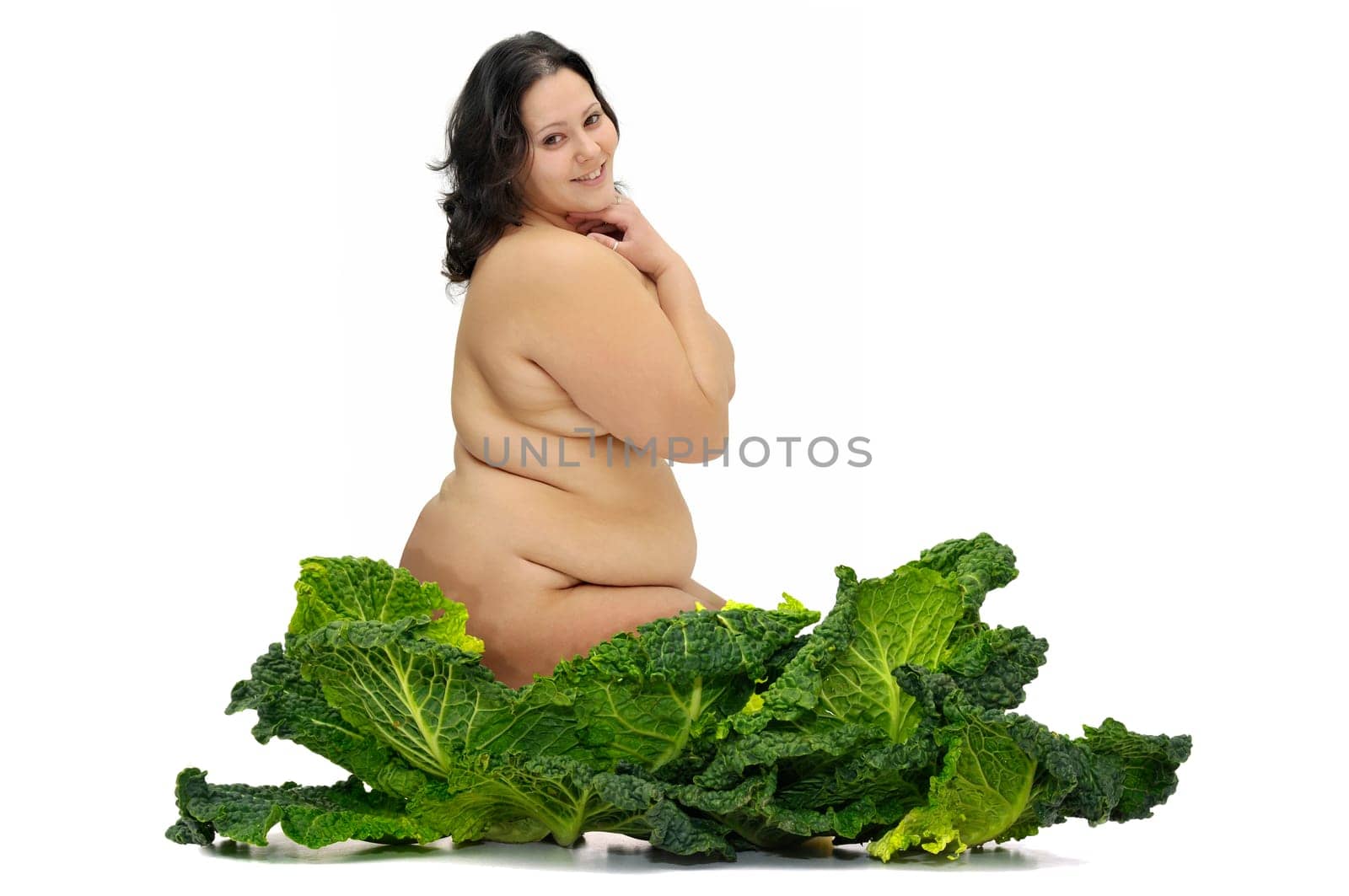 Beautiful large girl with vegetables isolated in white