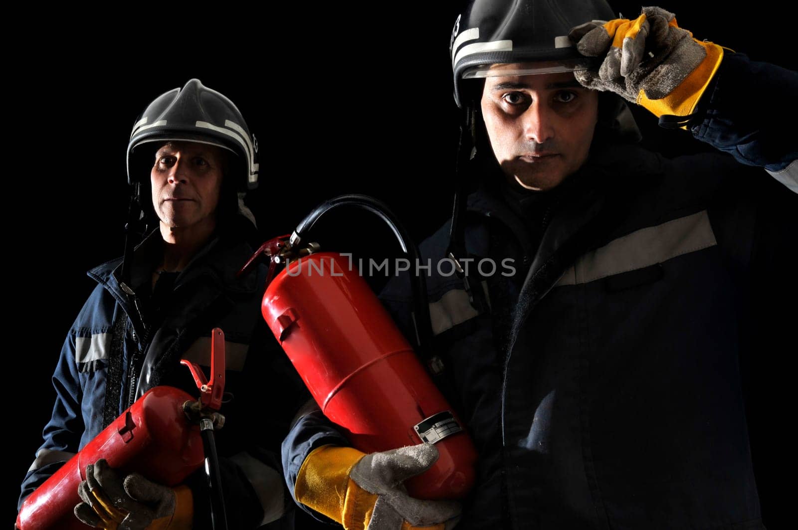 Dramatic image of firemen team in uniform