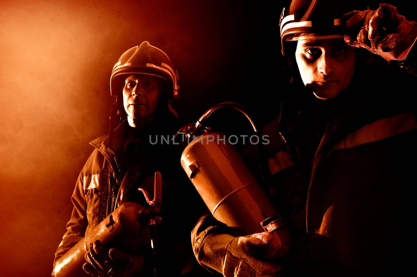 Dramatic image of firemen team in uniform