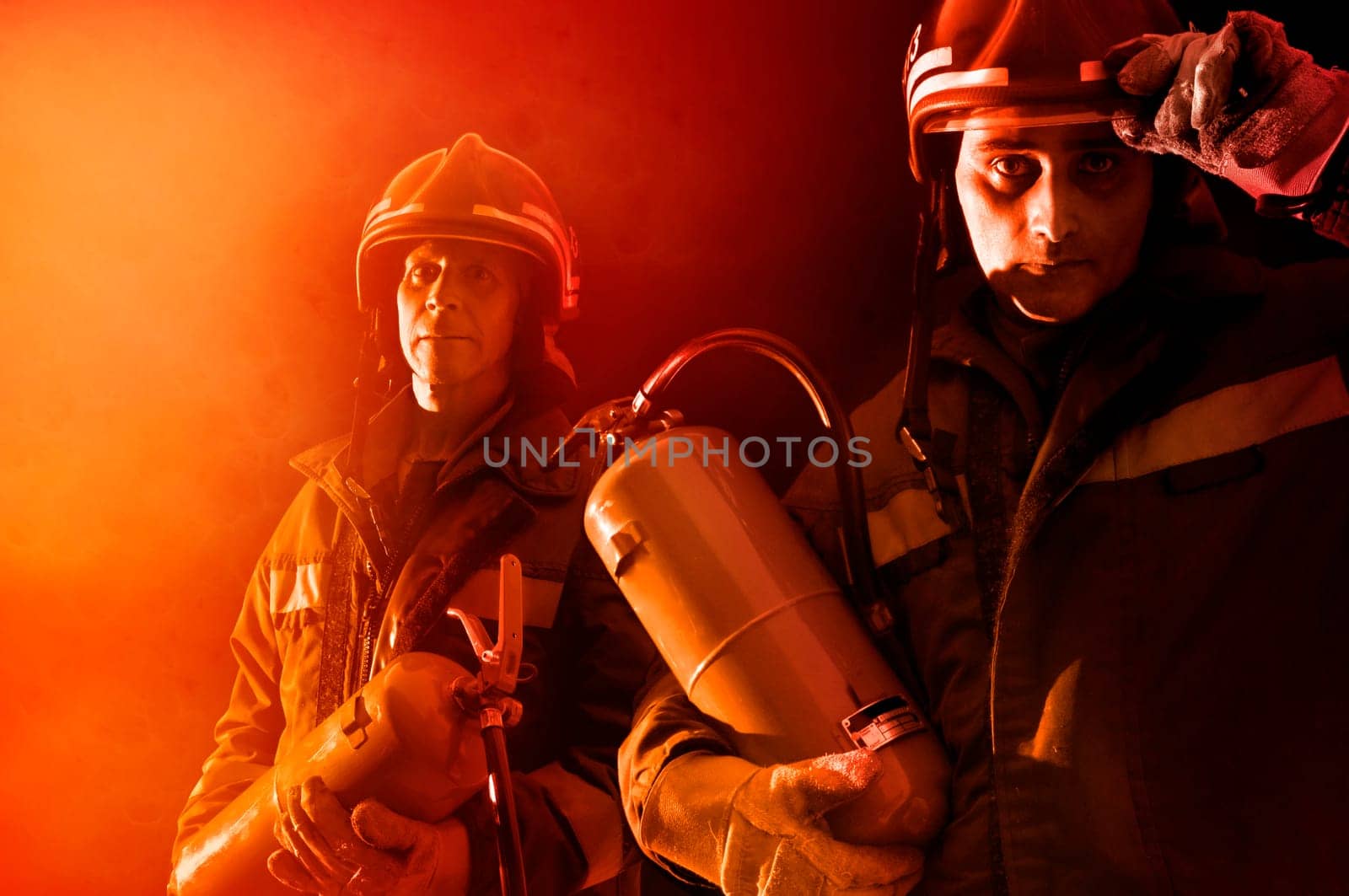 Dramatic image of firemen team in uniform
