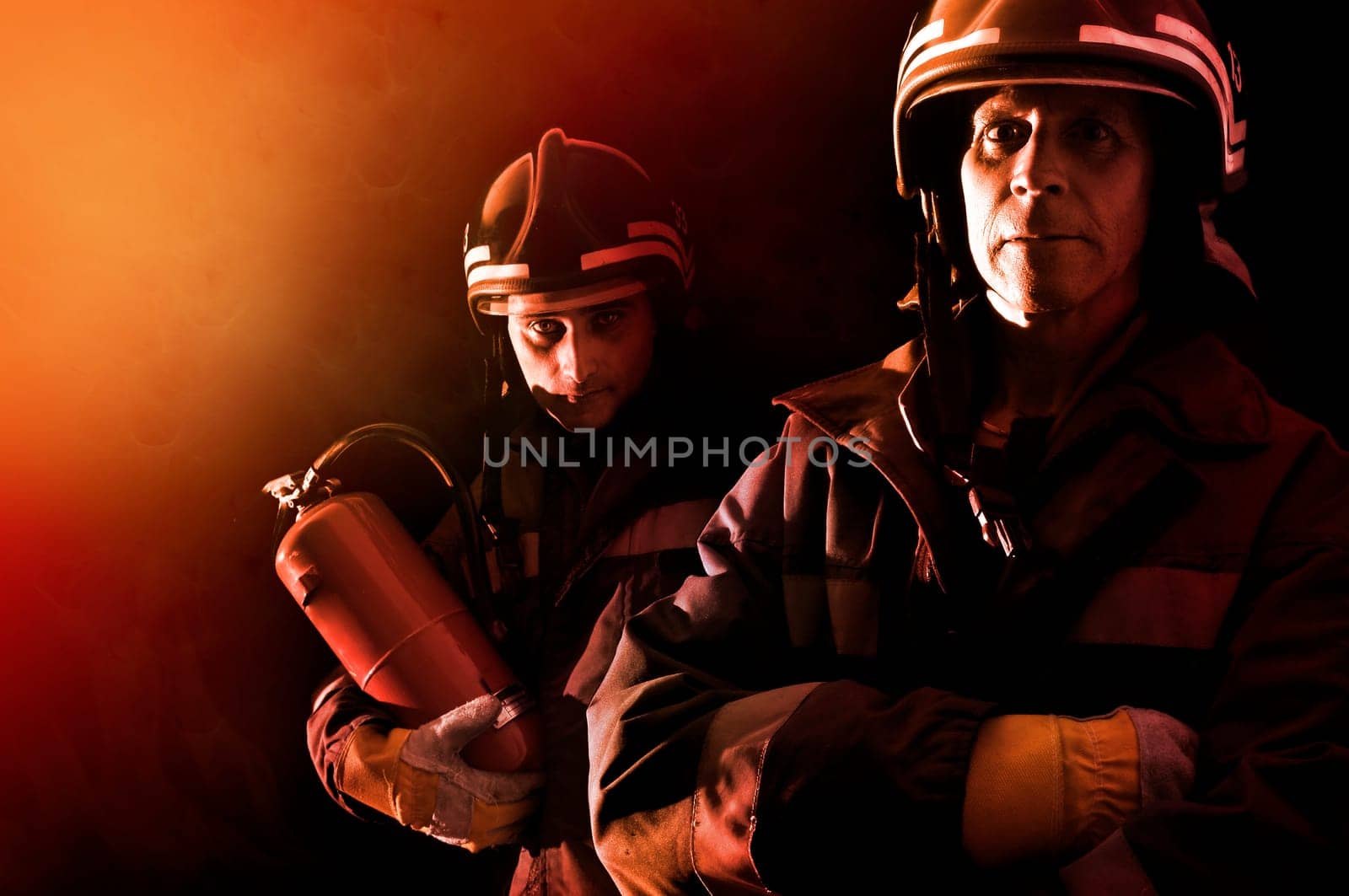 Dramatic image of firemen team in uniform