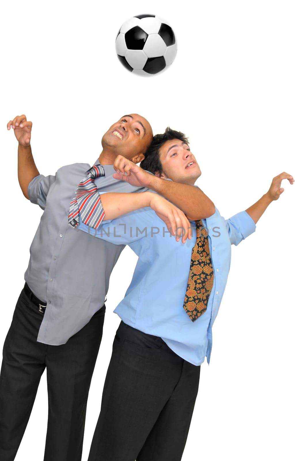 Two businessmen fighting for a ball header in a soccer game isolated in white