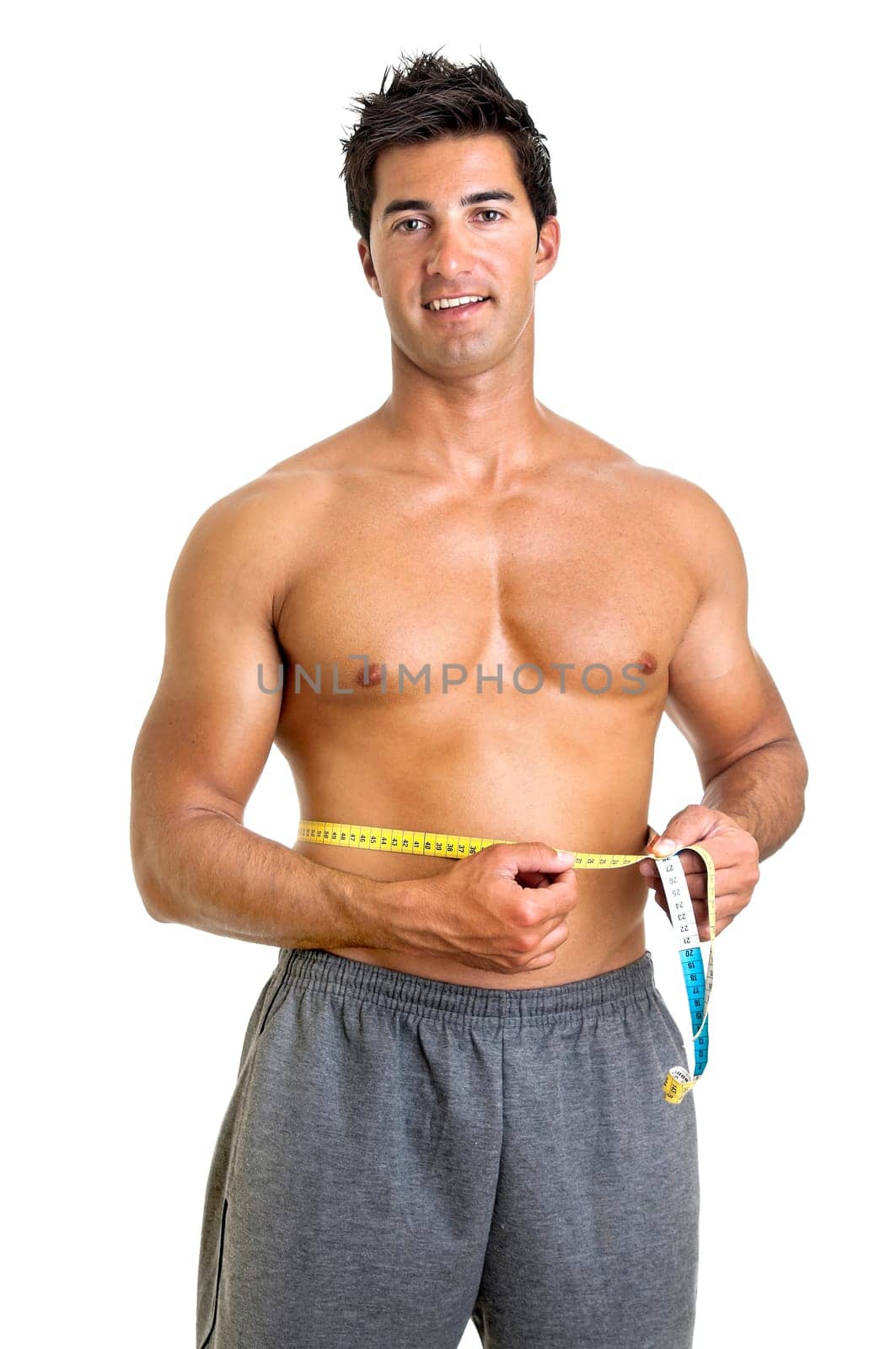 Muscular young man with measuring tape