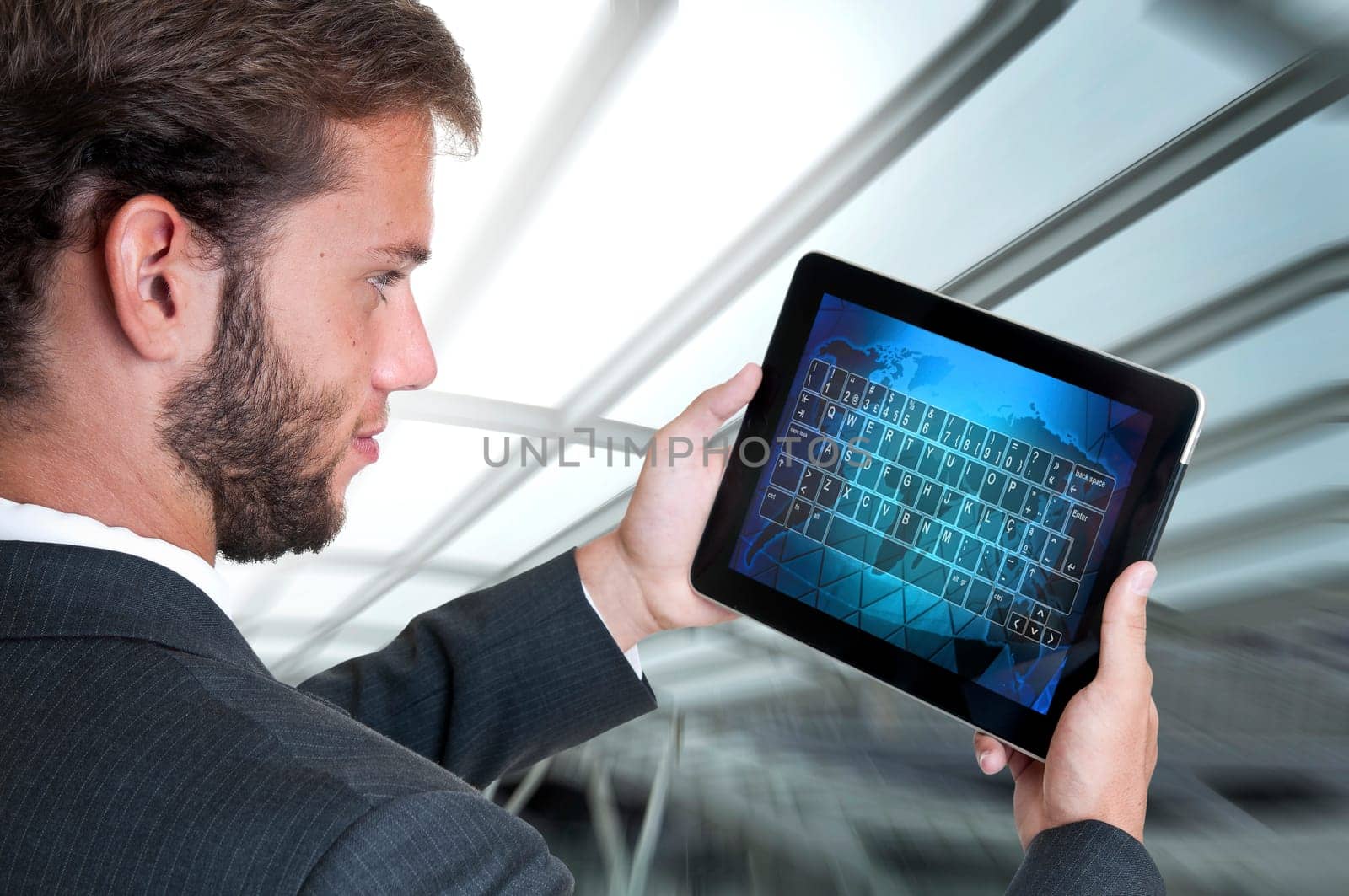 Young businessman with tablet isolated in white