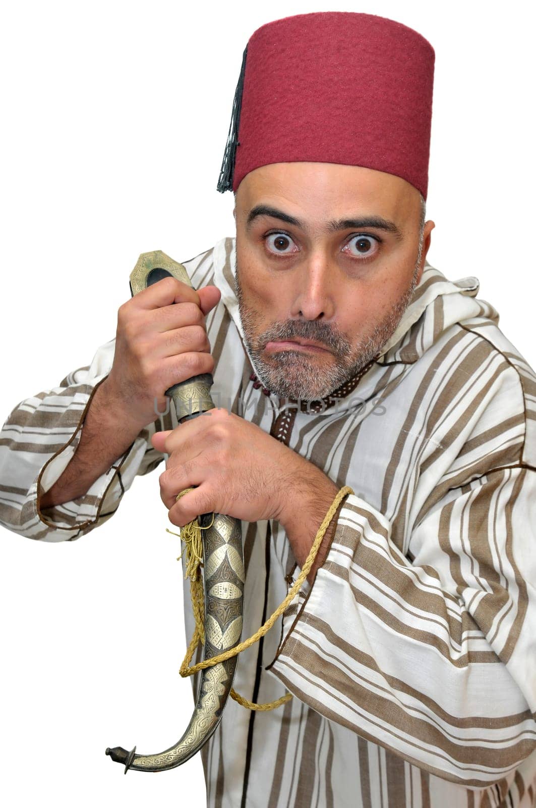 Arabic man with a dagger making funny faces isolated in white