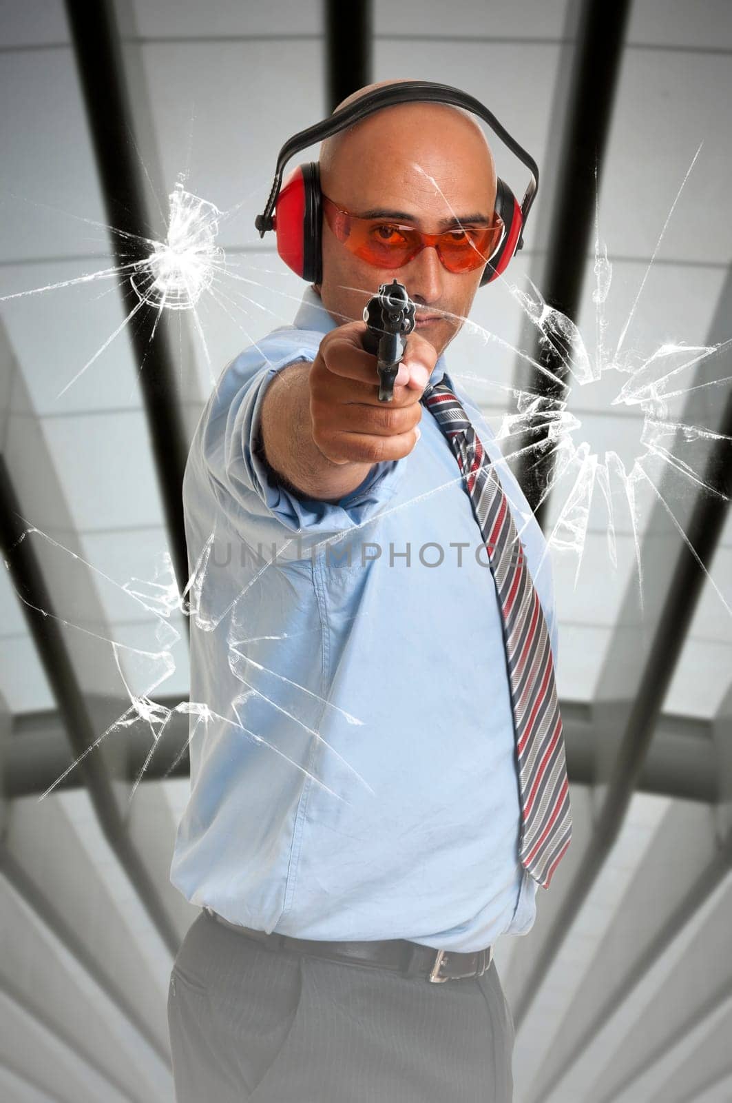 Man with gun shooting through glass window