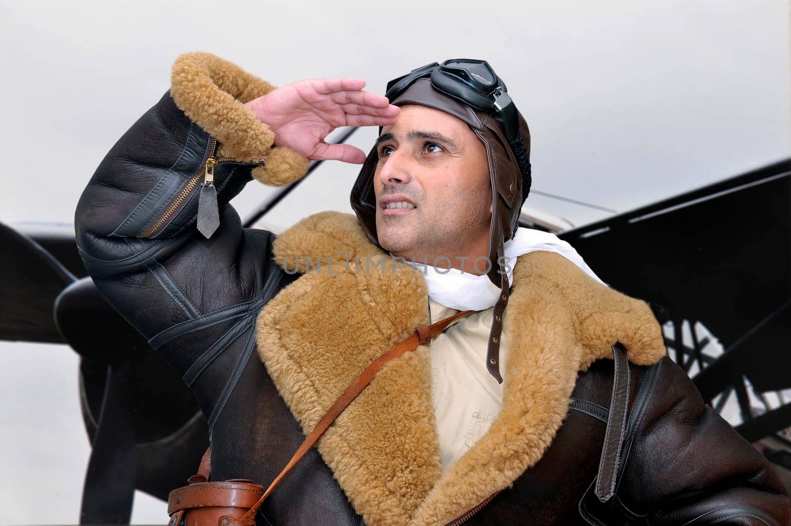 WWII fighter pilot looking to the sky