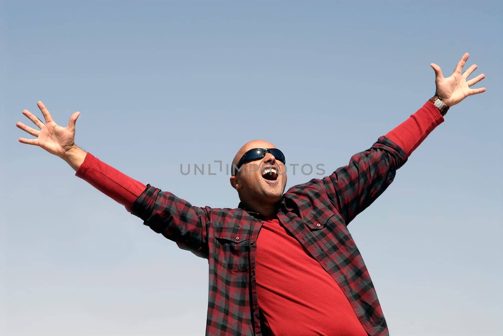 Happy man posing outdoors with sunglasses