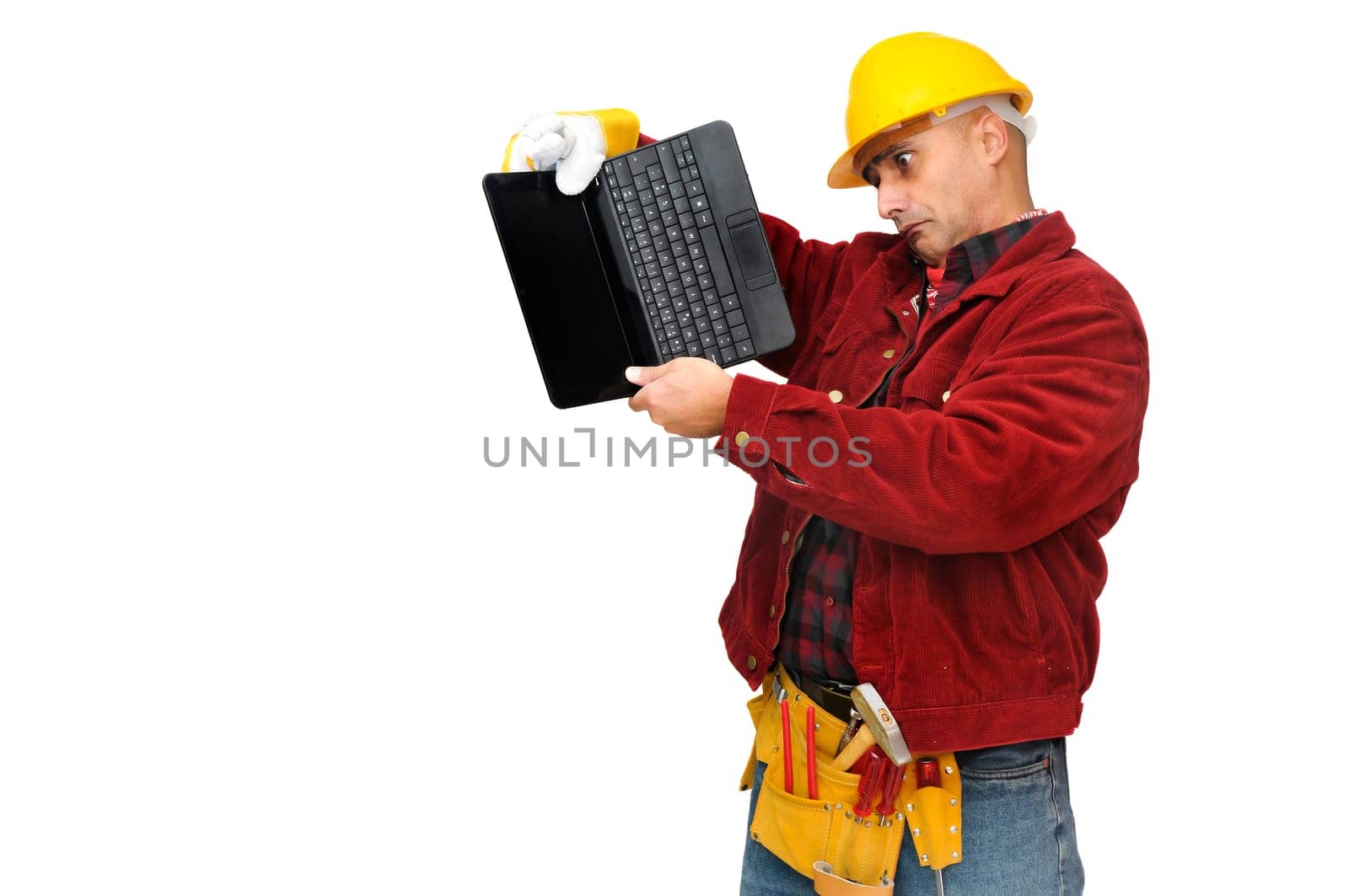 Confused construction worker with laptop isolated in white