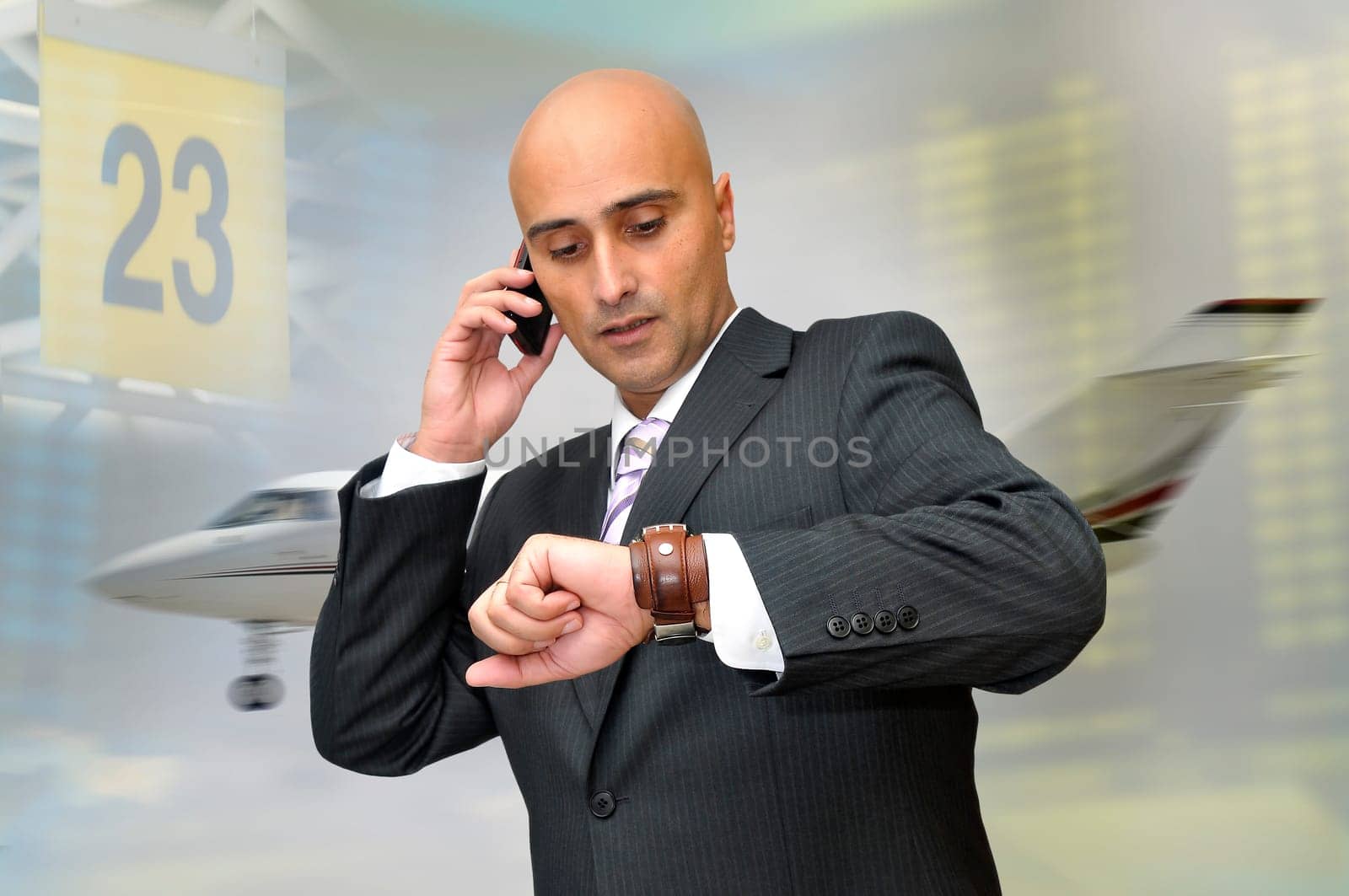 Businessman with cellphone and a jet plane passing behind