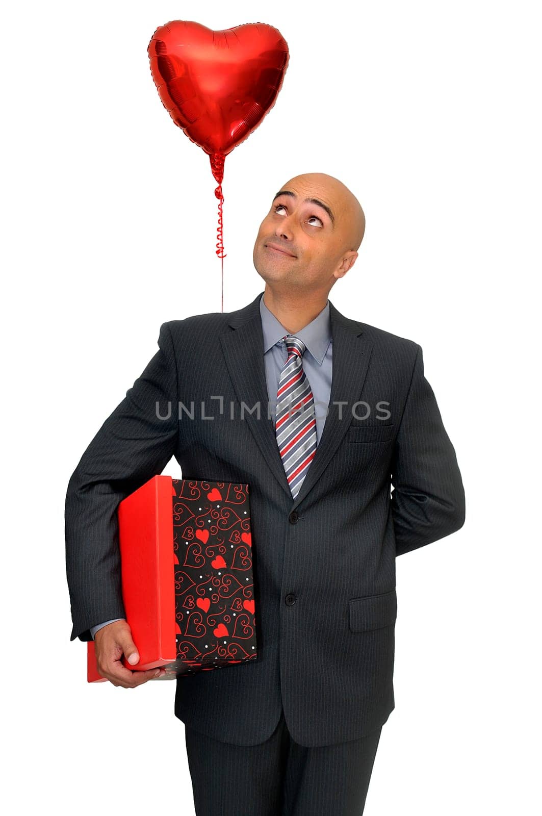 Man in suit with valentine's gift and heart shaped balloon