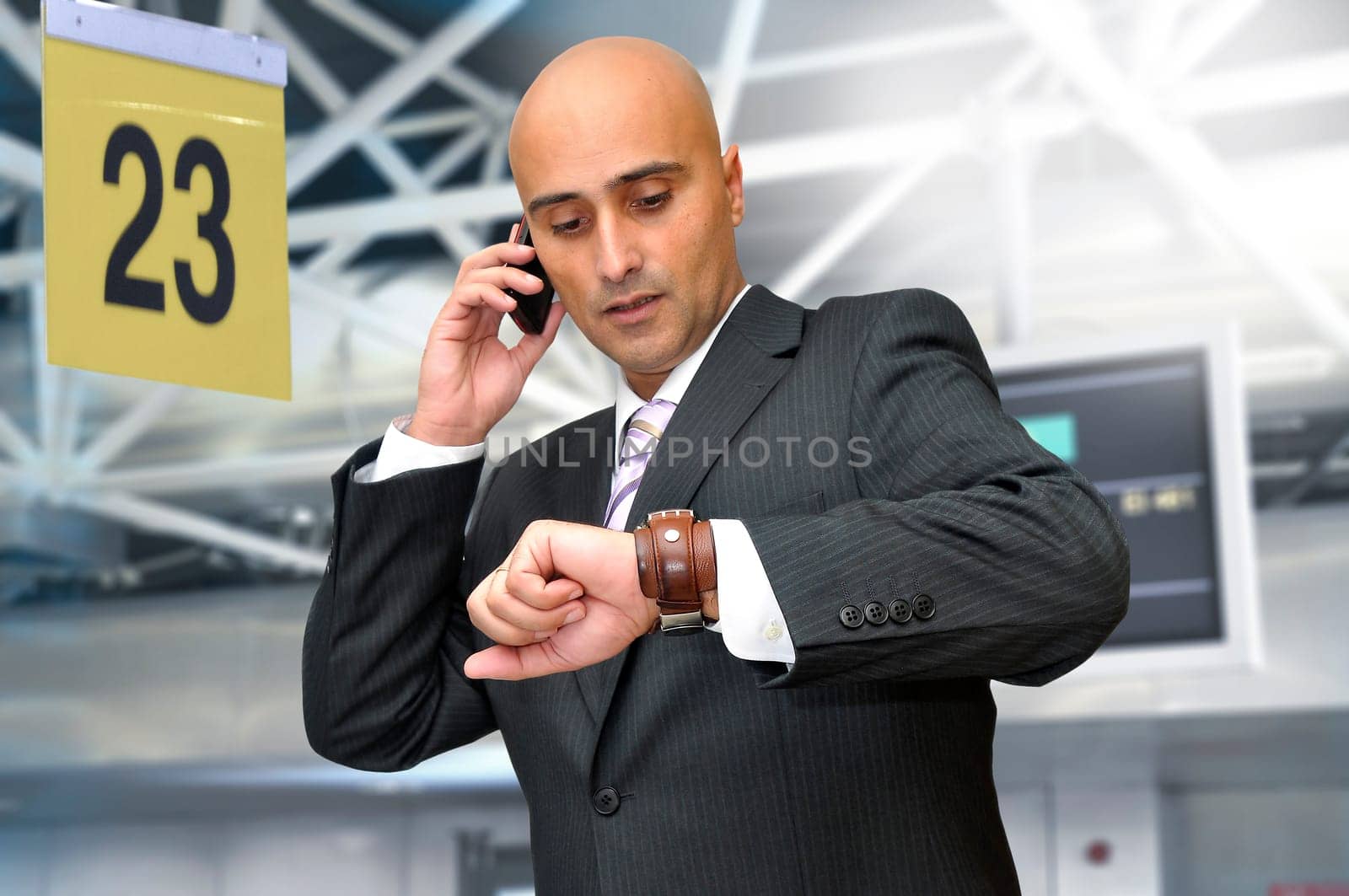 Businessman with cellphone in the airport
