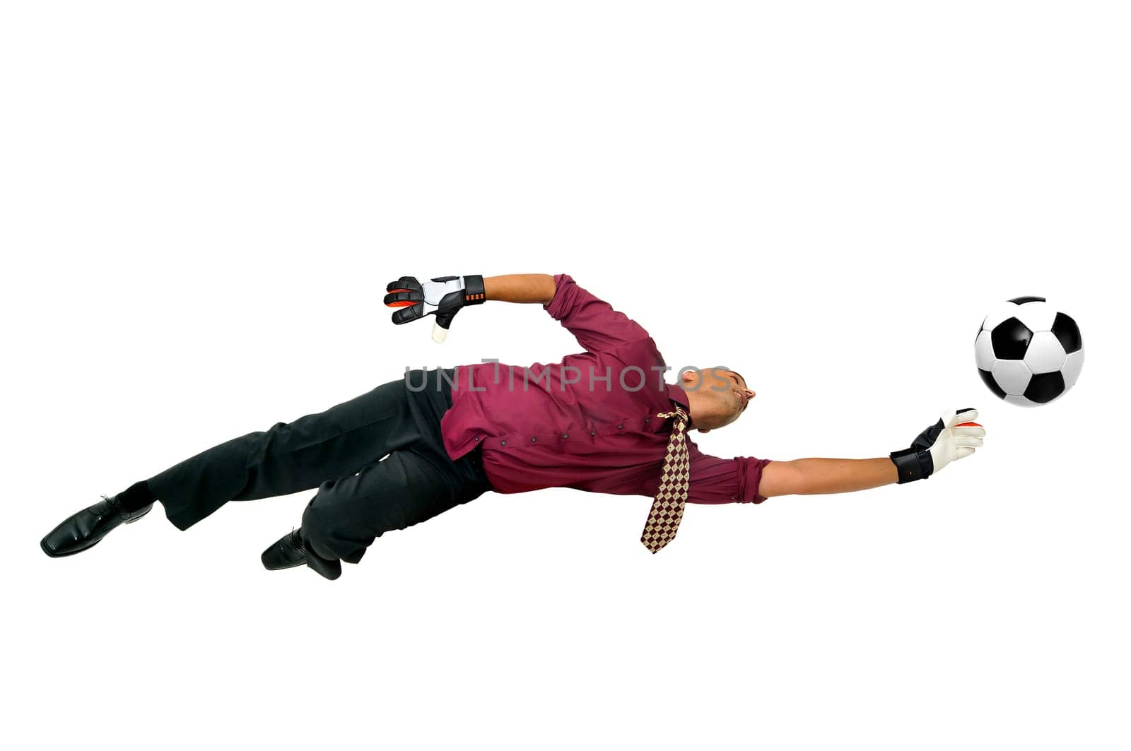 Businessman goalkeeper with gloves in a acrobatic pose with a soccer ball isolated in white