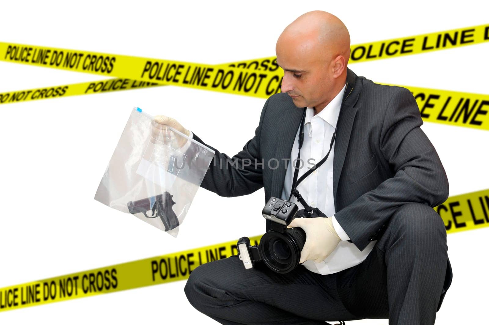Police CSI investigator with a camera holding a bag with a gun