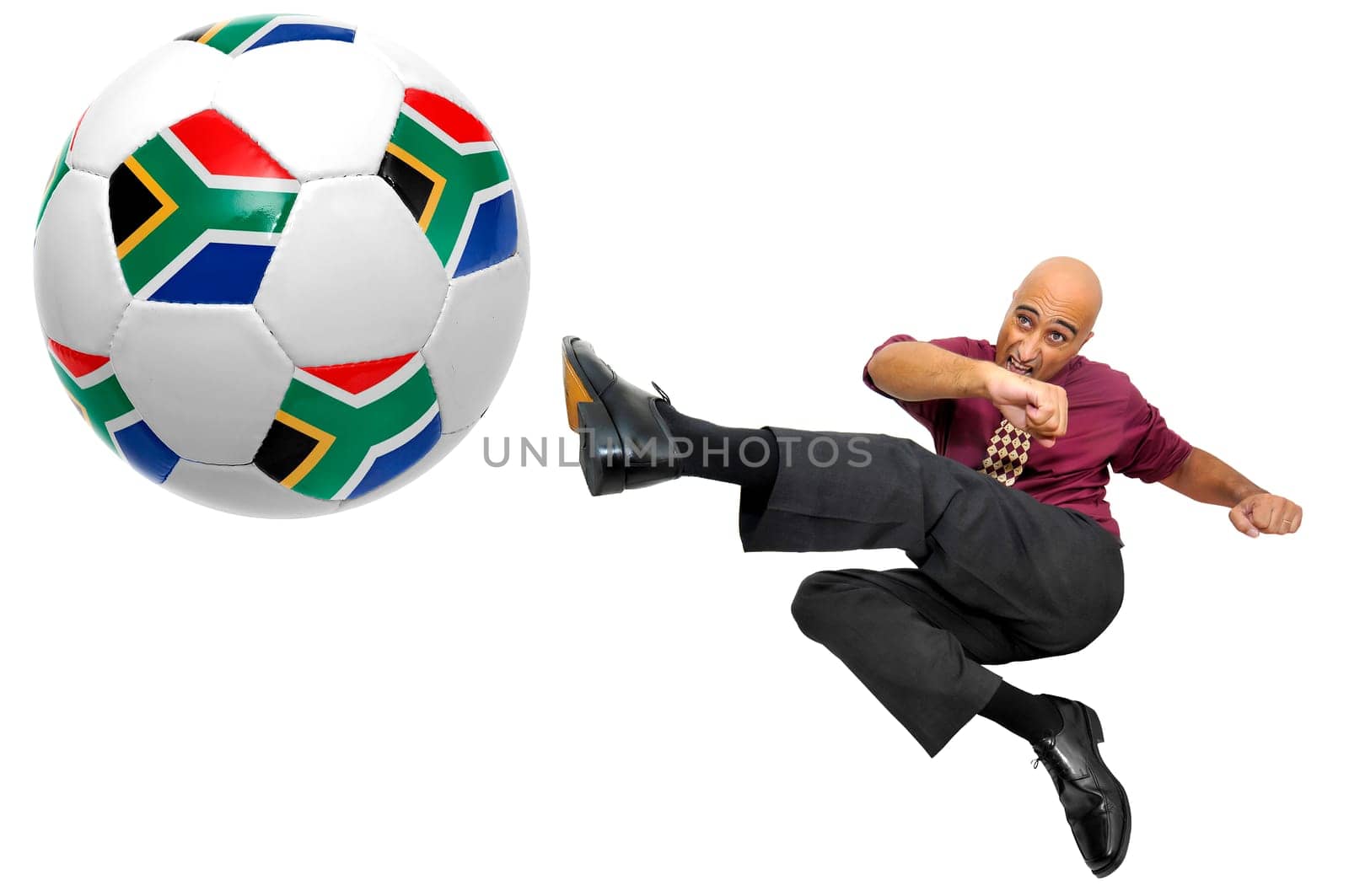 Businessman in a acrobatic pose with a soccer ball isolated in white
