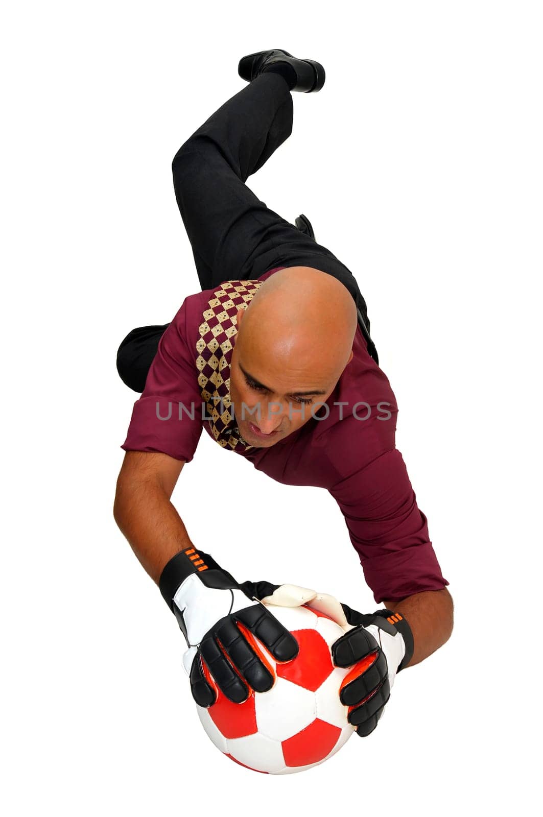 Businessman goalkeeper with gloves in a acrobatic pose with a soccer ball isolated in white