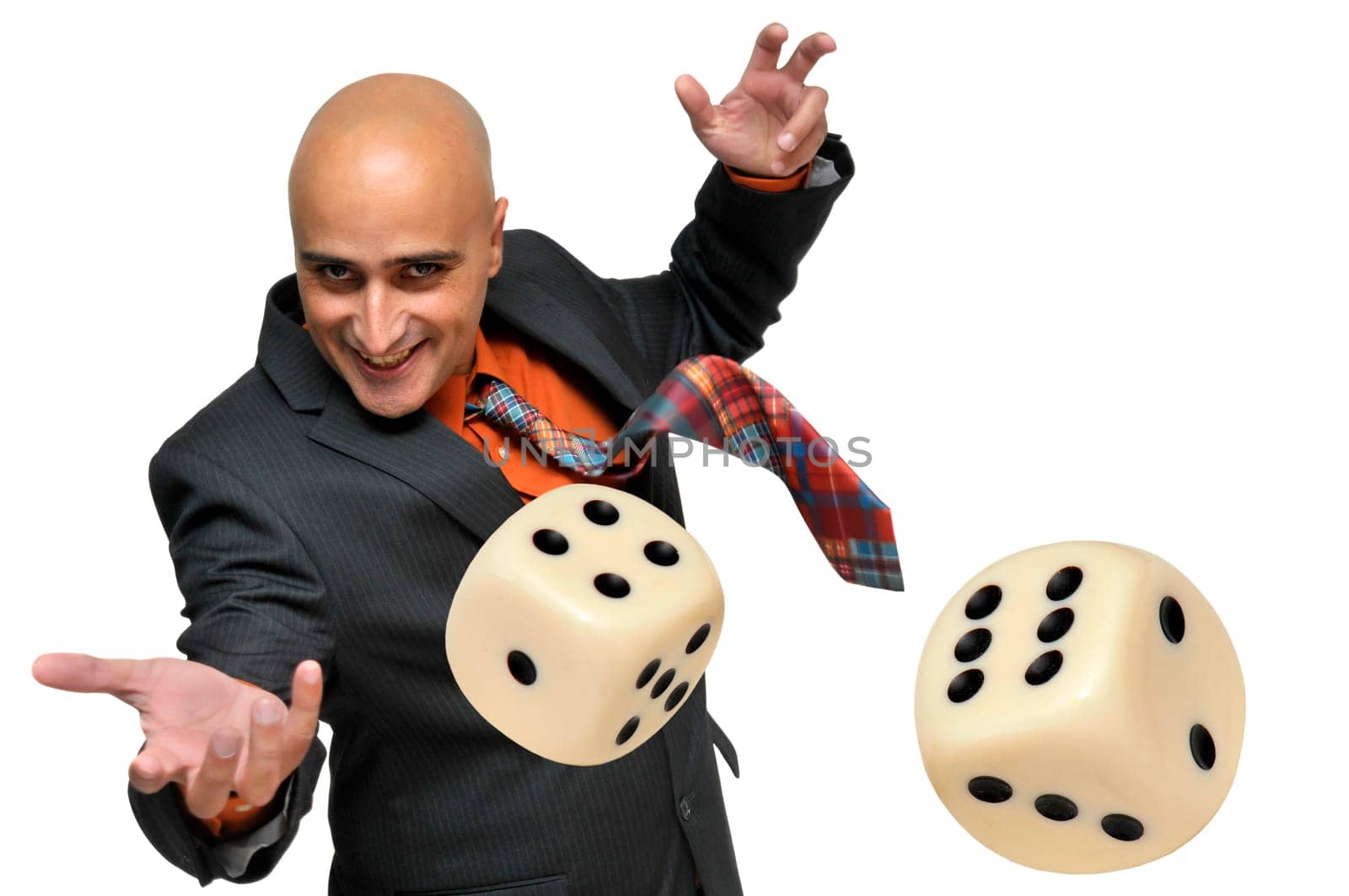 Man in a suit playing dice isolated in white