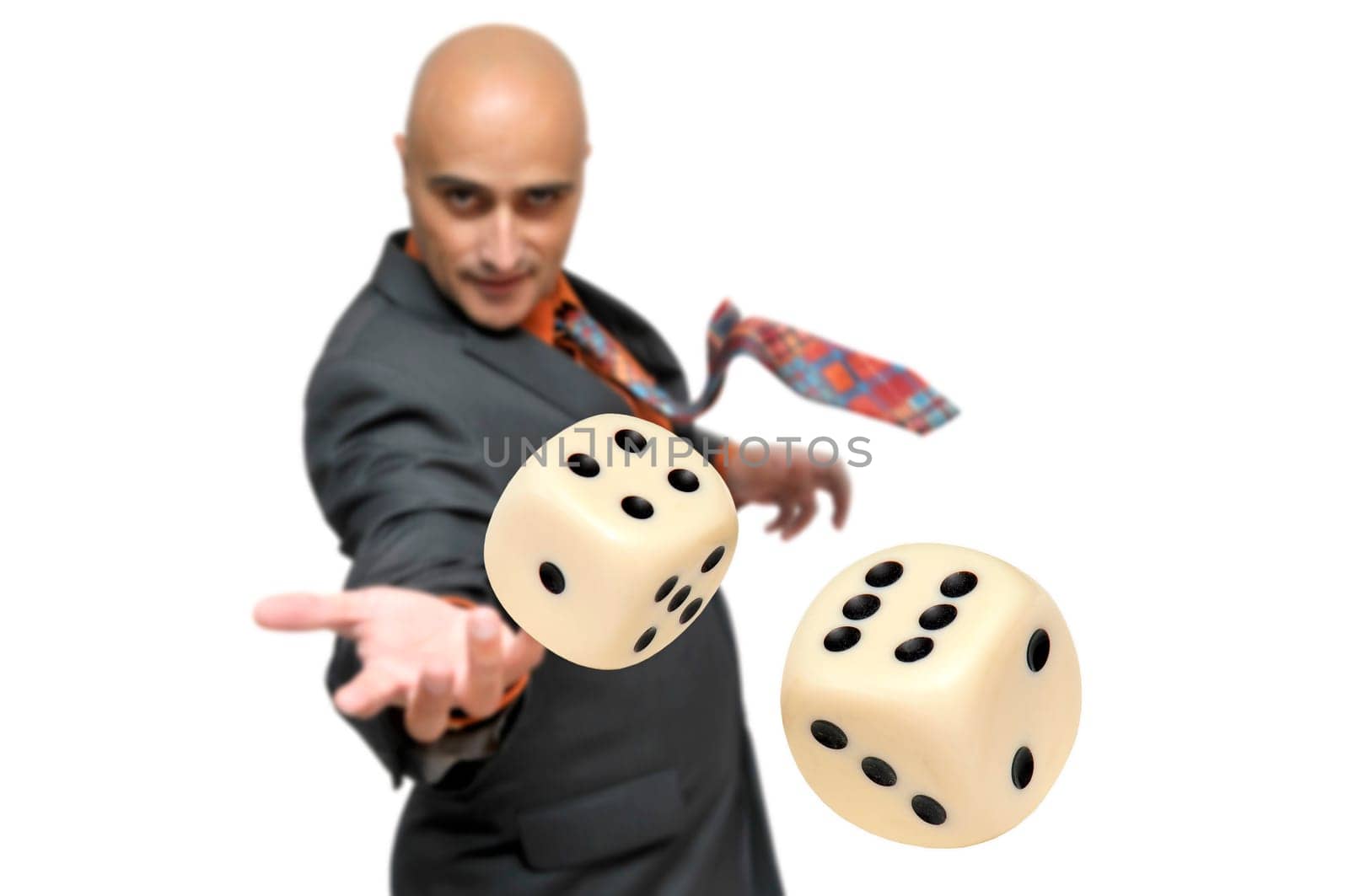 Man in a suit playing dice isolated in white