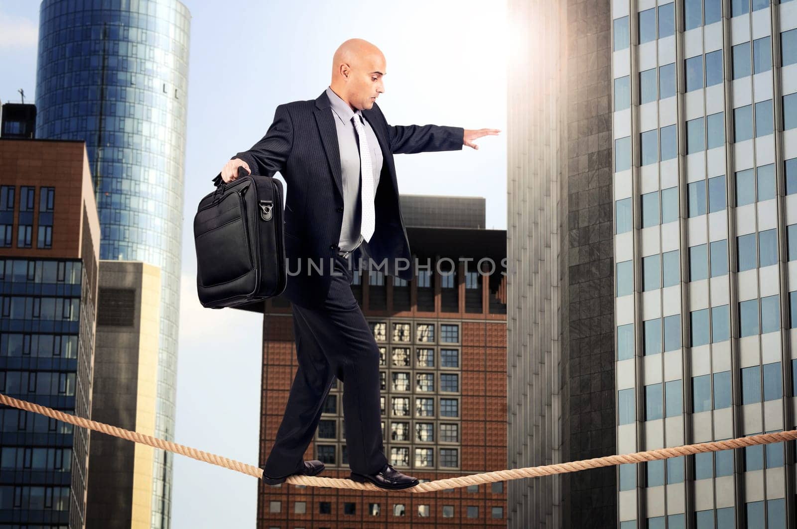 Businessman walking a rope in despair