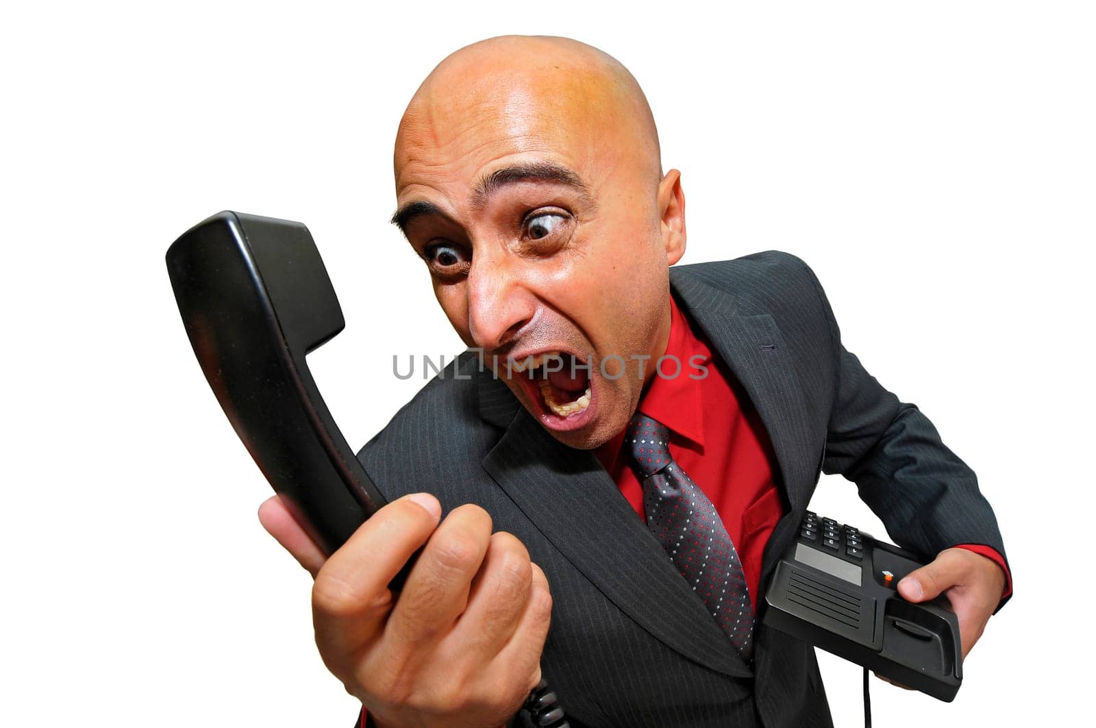 Angry businessman shouting at a telephone isolated in white
