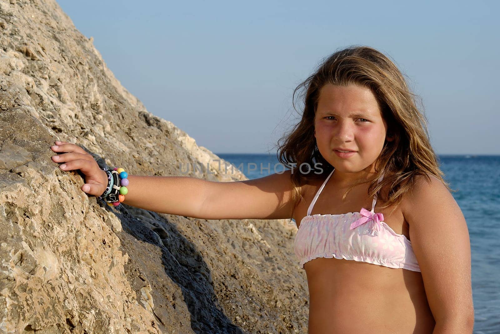 Beautiful young girl posing in the beach