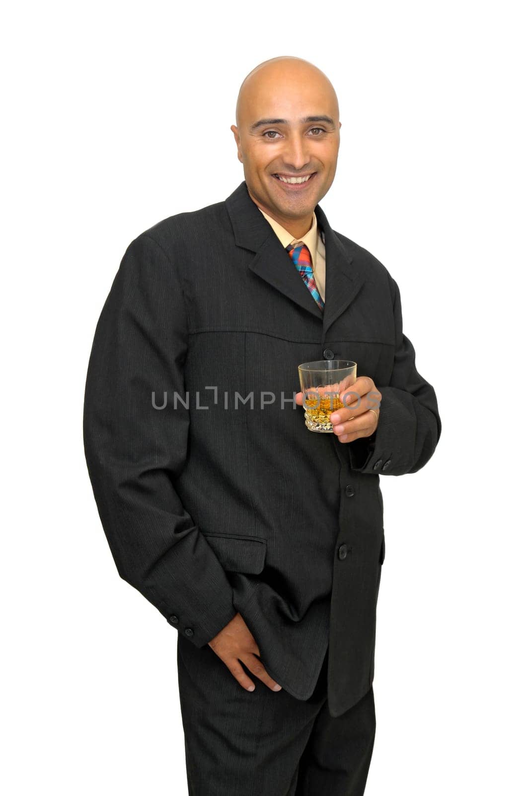 Businessman with a glass of whiskey isolated in white
