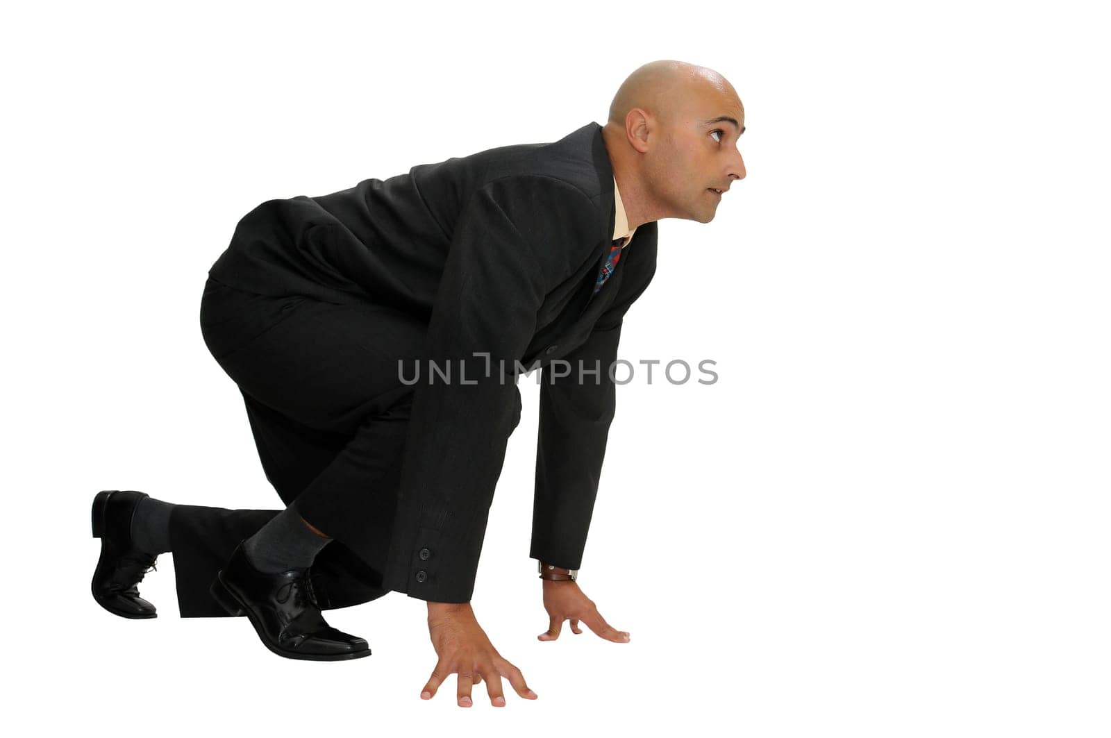 Businessman in a race start position isolated in white
