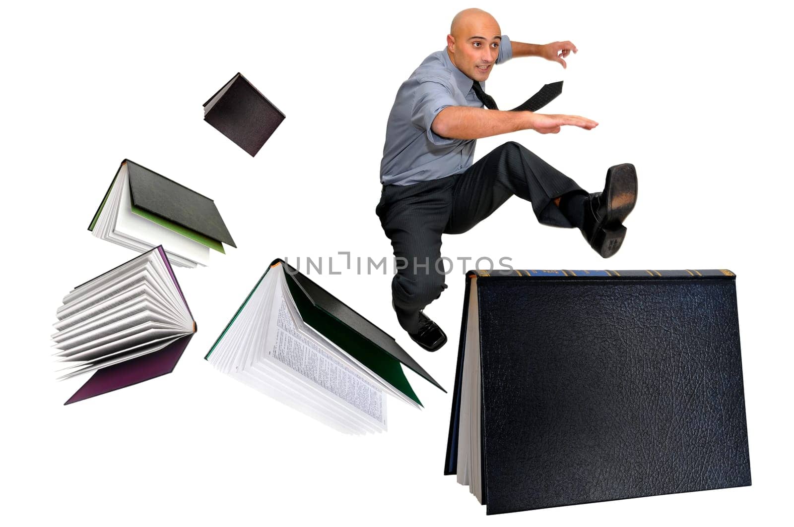 Businessman jumping over books isolated in white