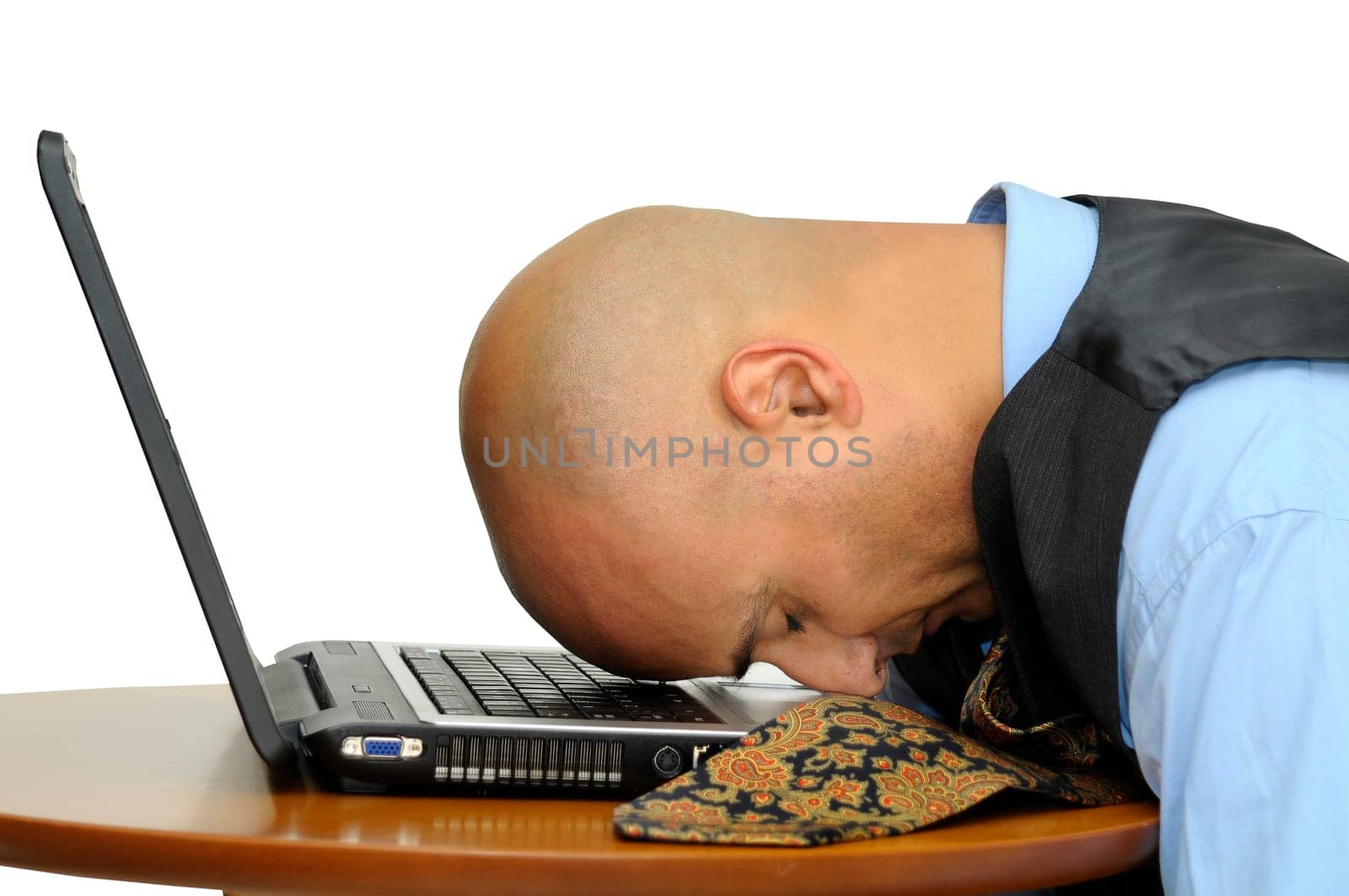 Tired businessman sleeping over computer