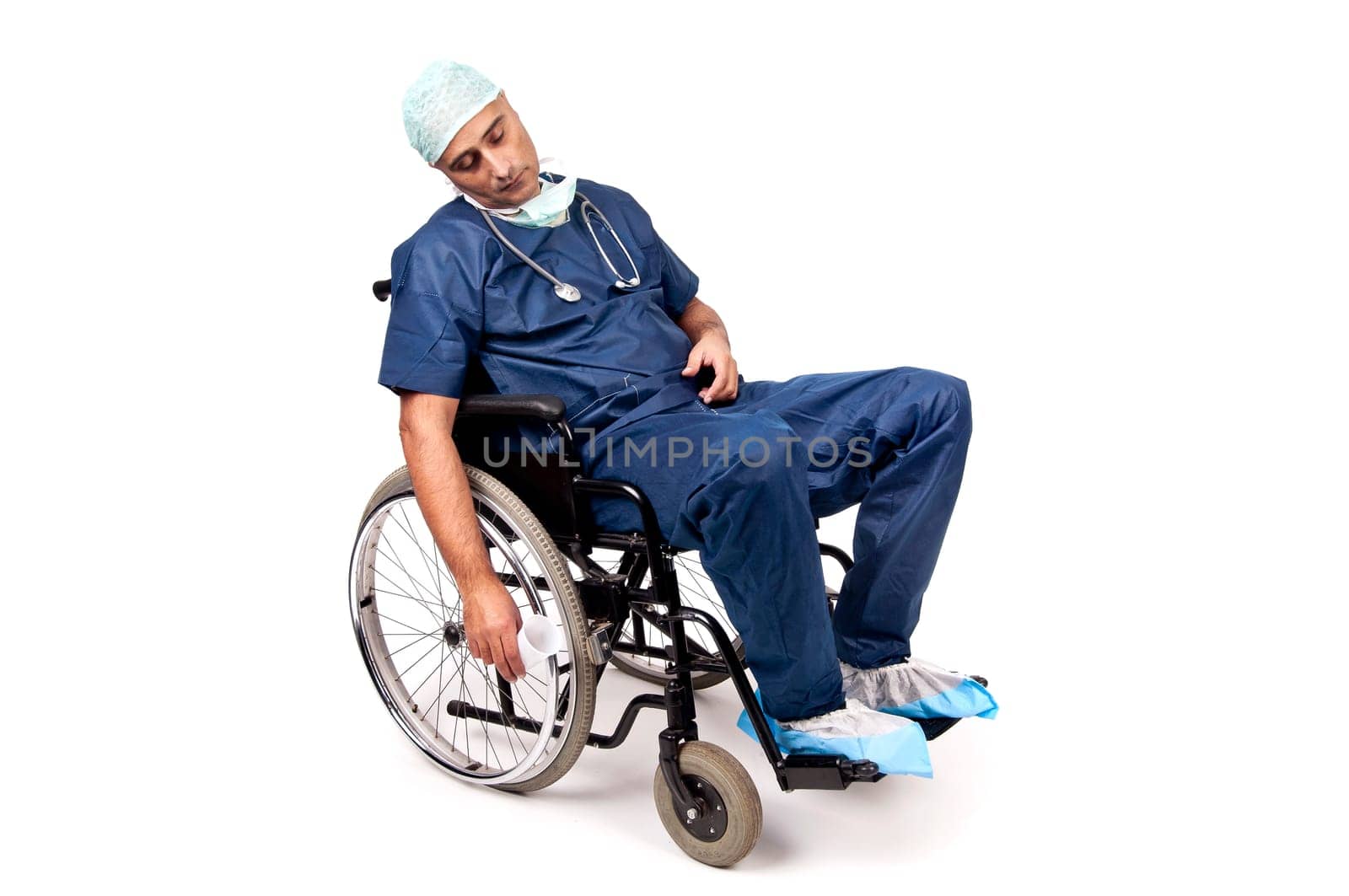 Tired doctor sleeping in a wheelchair