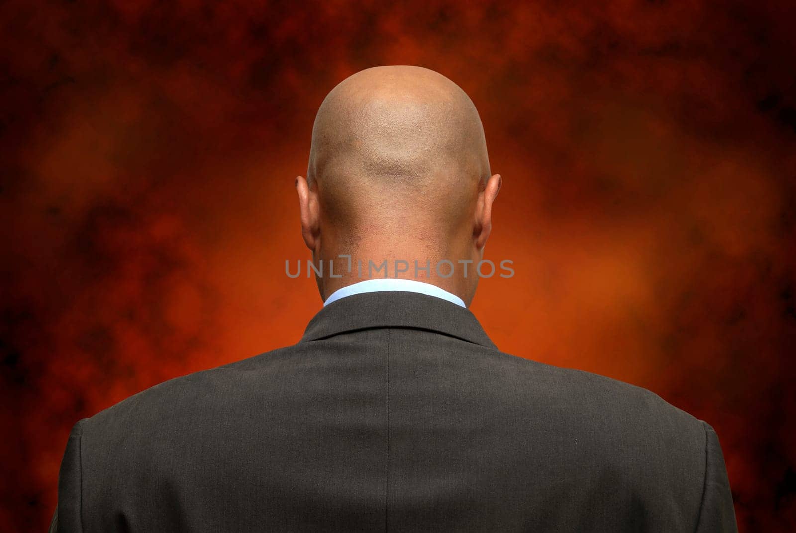 Businessman on is back with a dark background