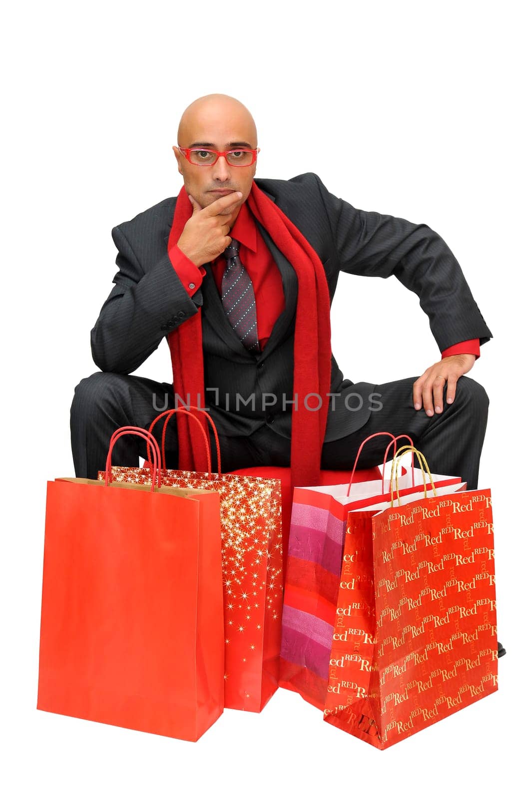Businessman posing with shopping bags isolated in white
