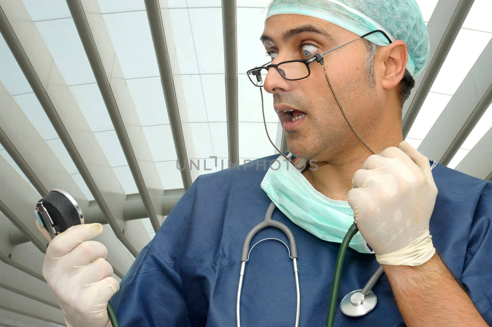 Doctor with tension device and surprised face