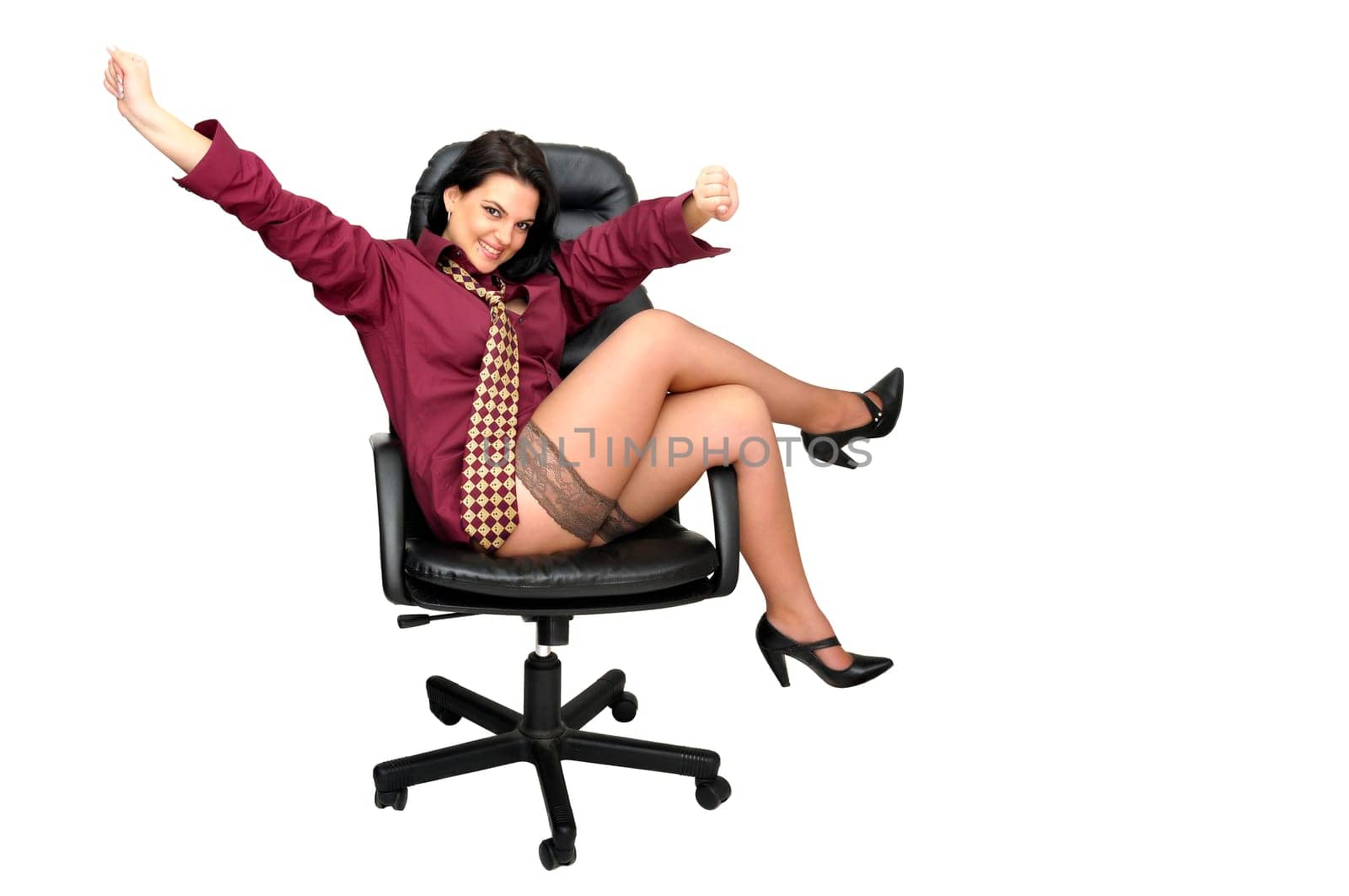 Sexy businesswoman in a chair with tie and stockings isolated in white